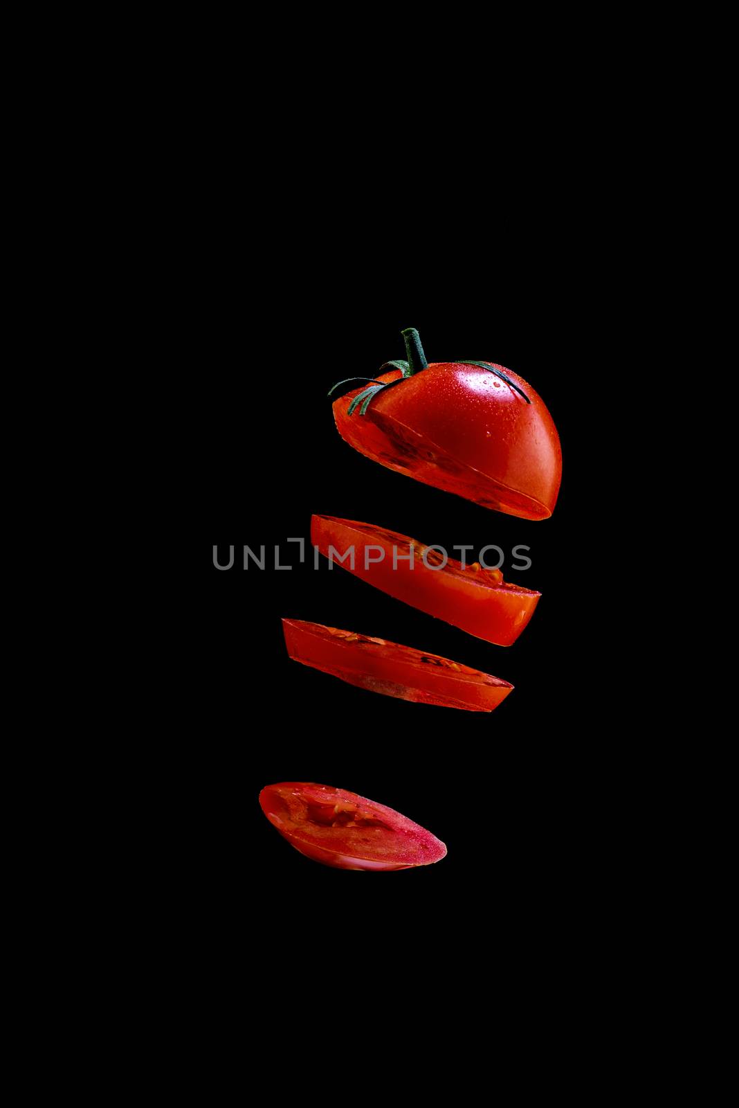 5 Flying tomato slices on a black background by dmitry_derenyuk