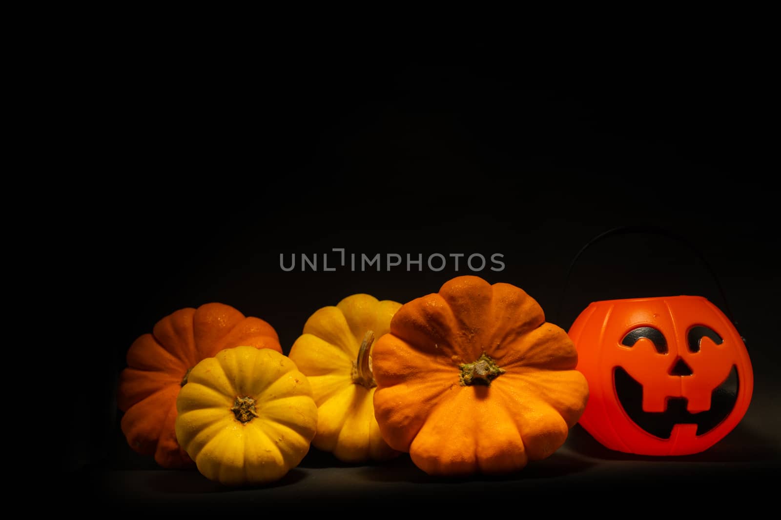 Halloween pumpkin on dark background with space for text by peerapixs