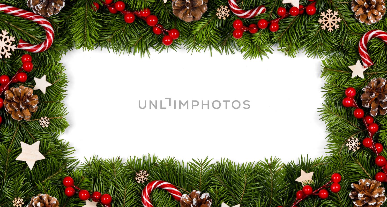 Christmas Border frame of tree branches on white background with copy space isolated, red and white decor, berries, stars, cones