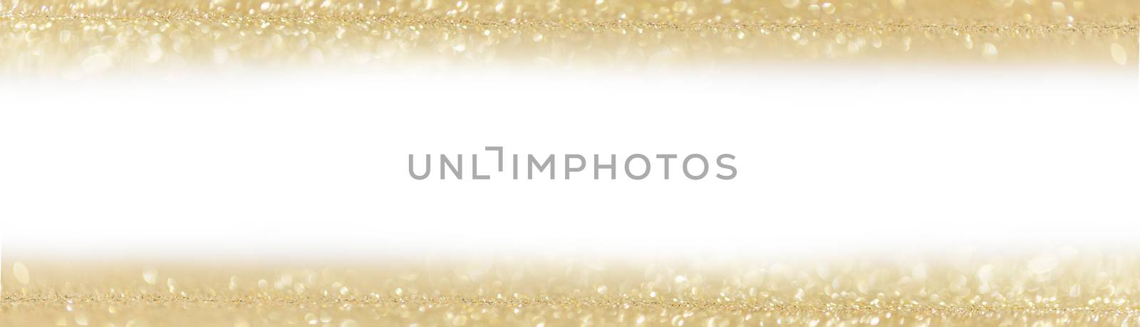 Golden festive glitter background with defocused lights , white copy space