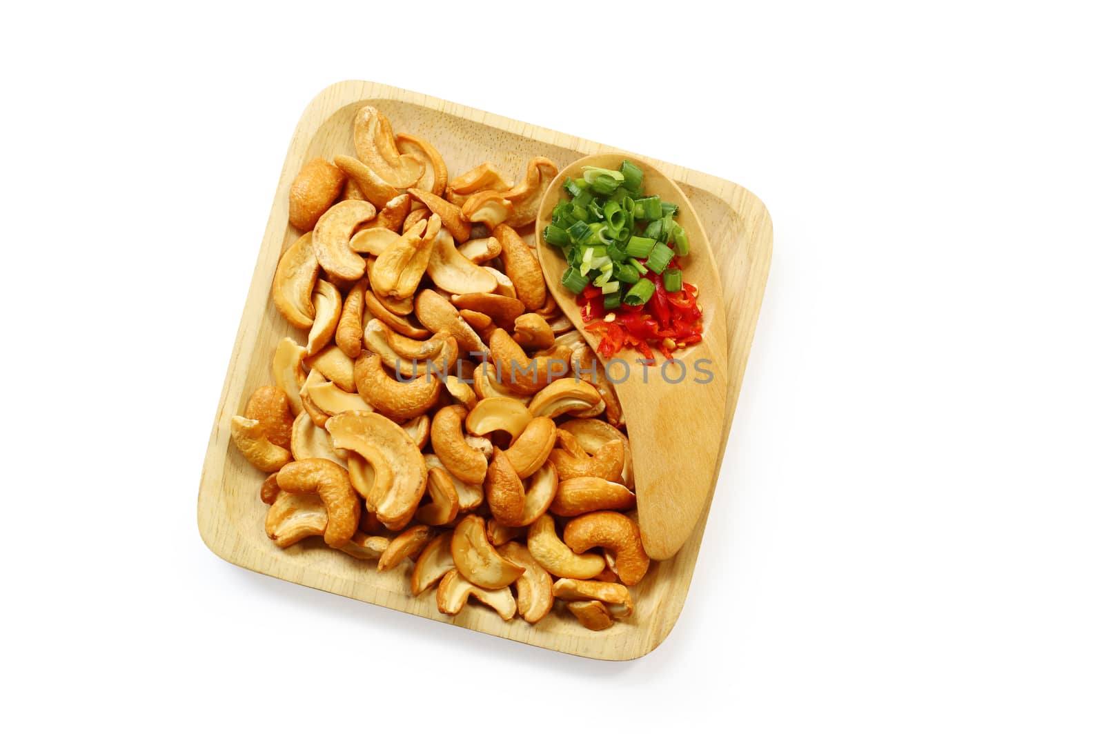 pile of roasted peanuts in a wooden bowl isolated on white background, clipping path.