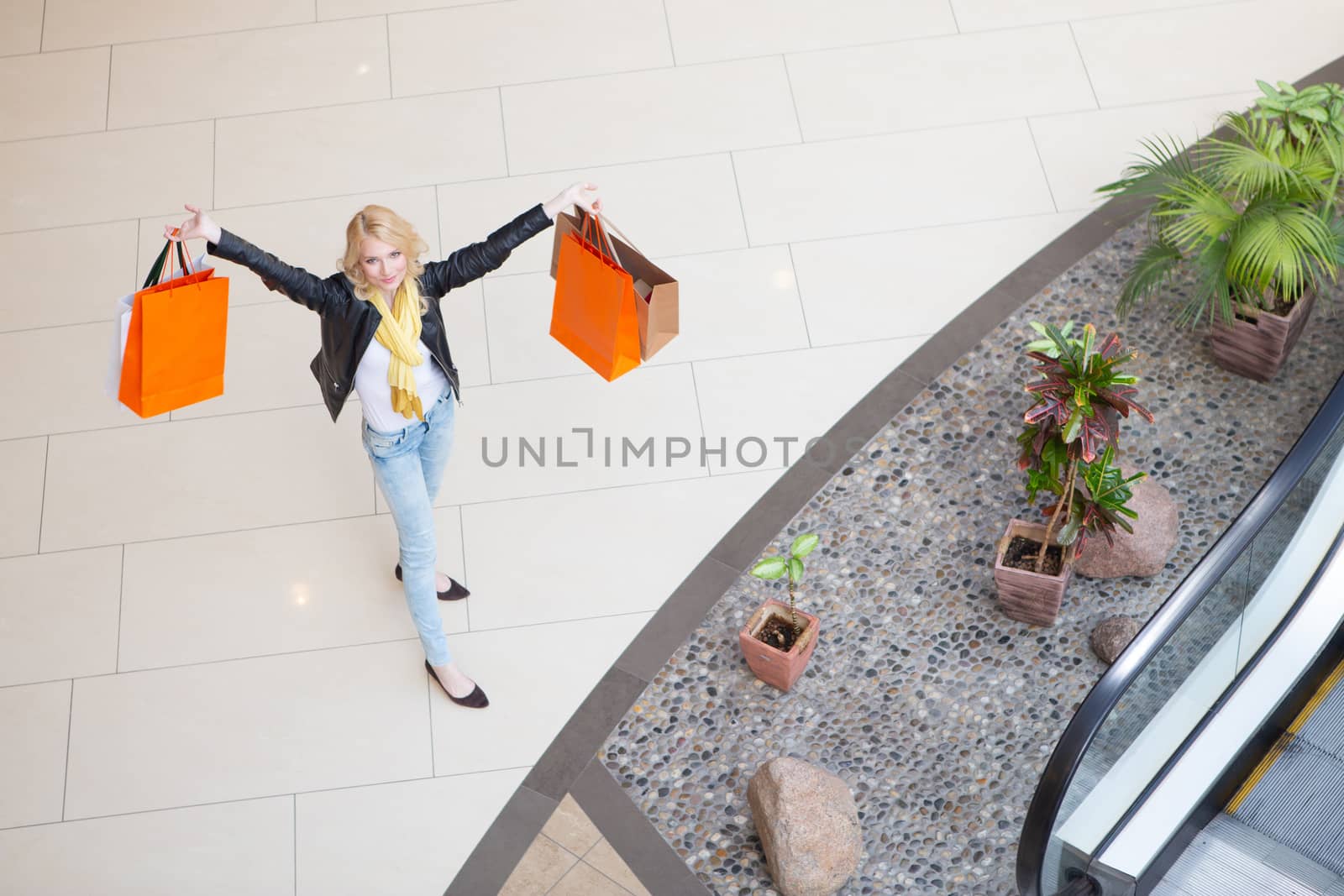 Sale and people - smiling woman with colorful shopping bags, top view