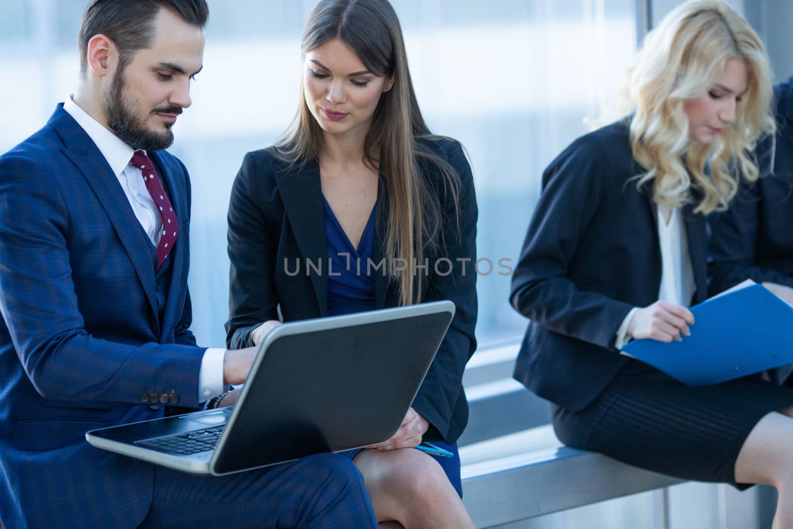 Business people working with documents on laptops at break