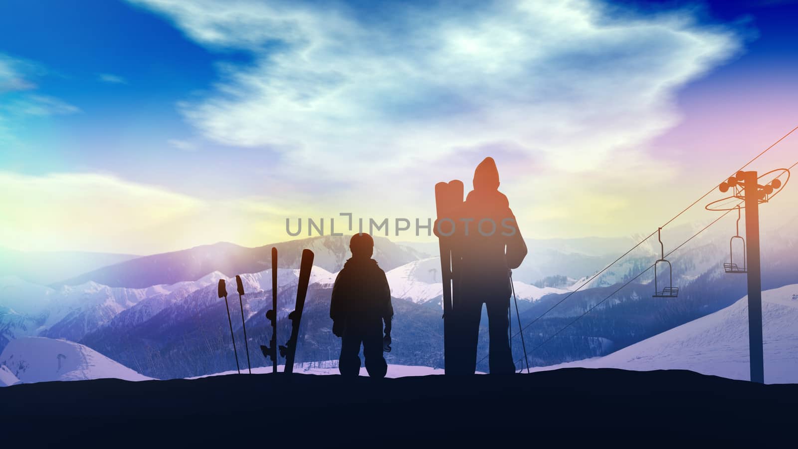 A family of skiers looking at the snowy mountains from the top.