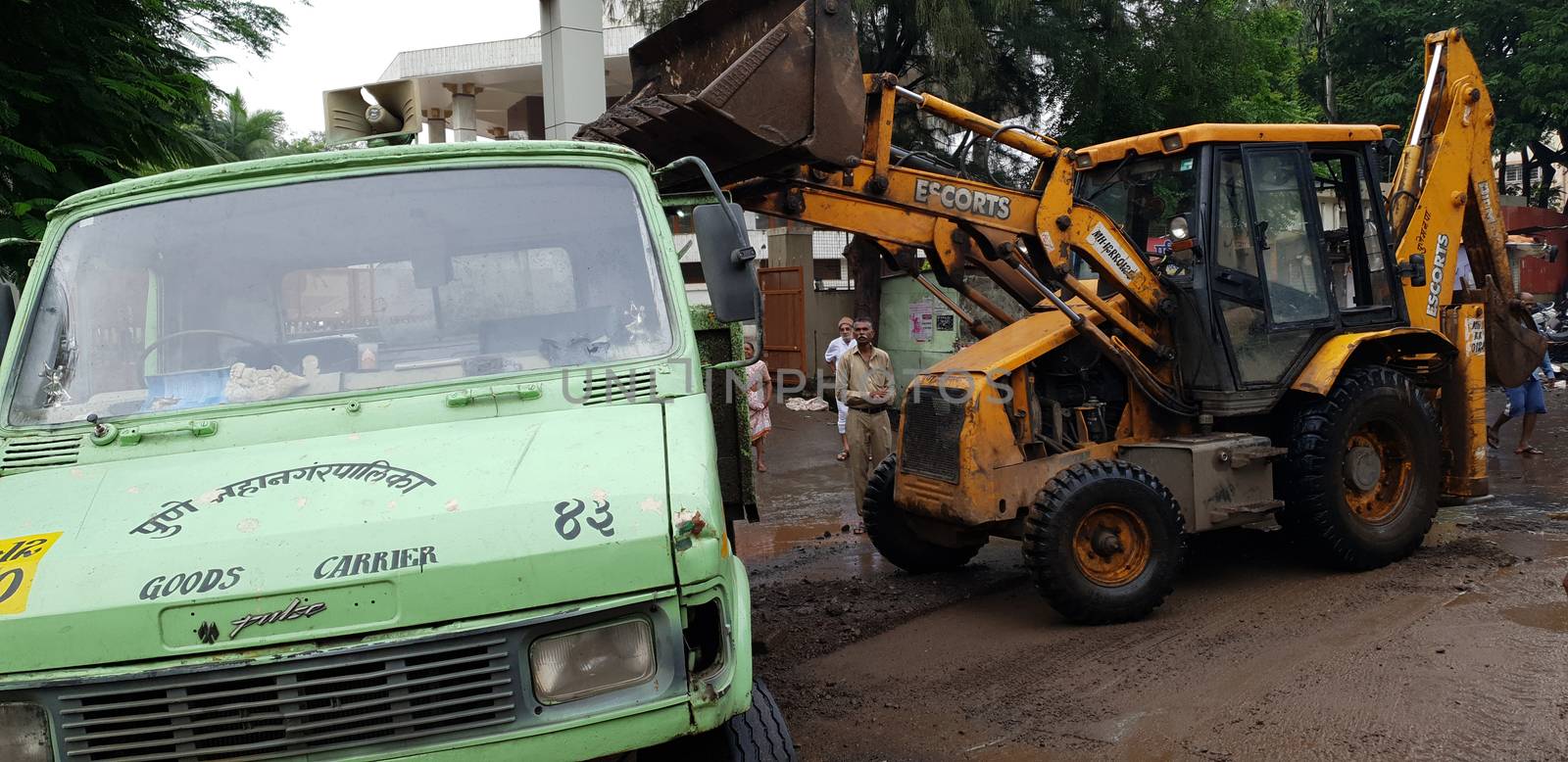 Pune, India - September 26, 2019: Government City Corporation workers help to clear the destruction done by floods in India.