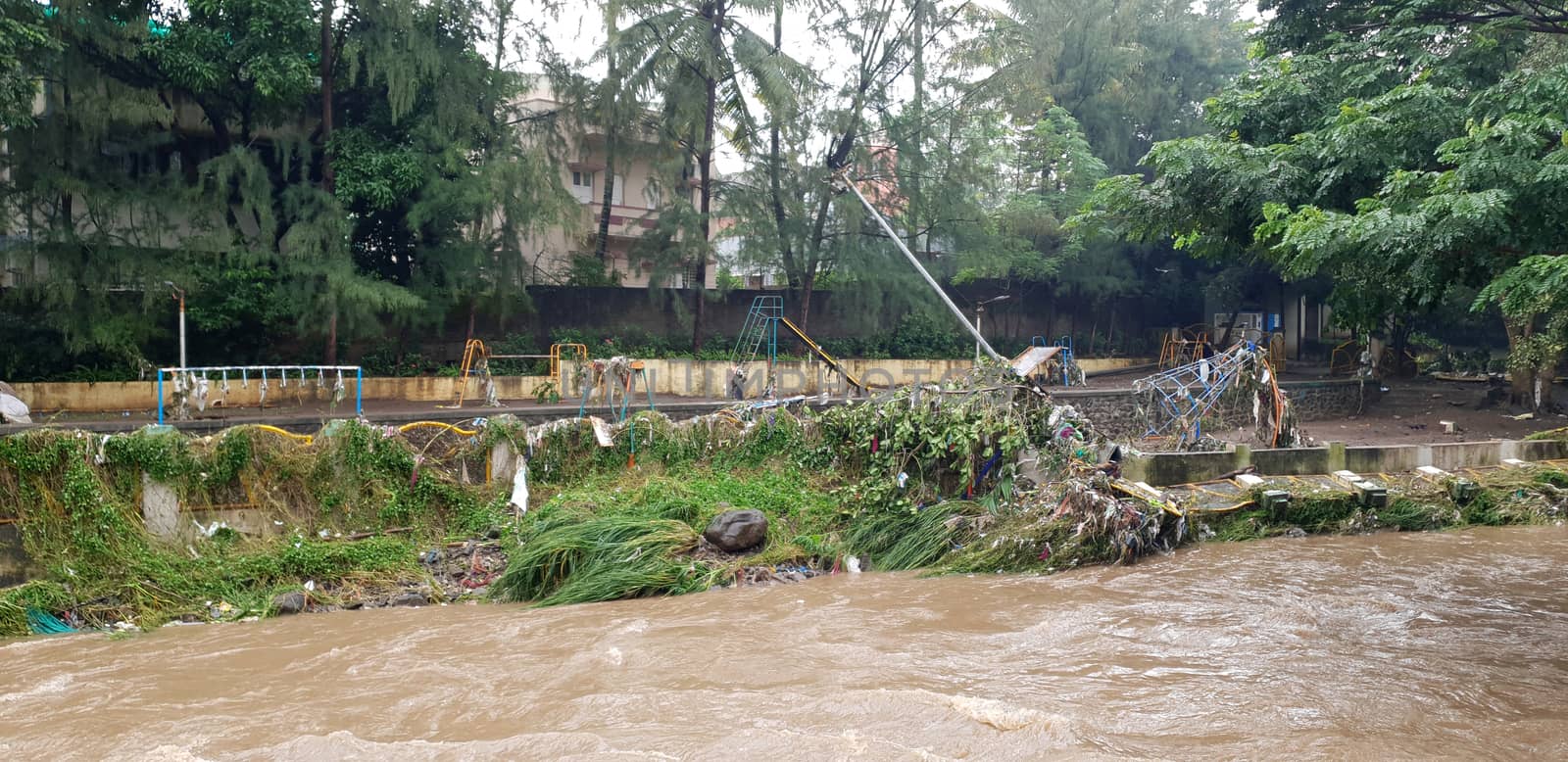 A childrens park destroyed near a river during floods in India during the monsoons.