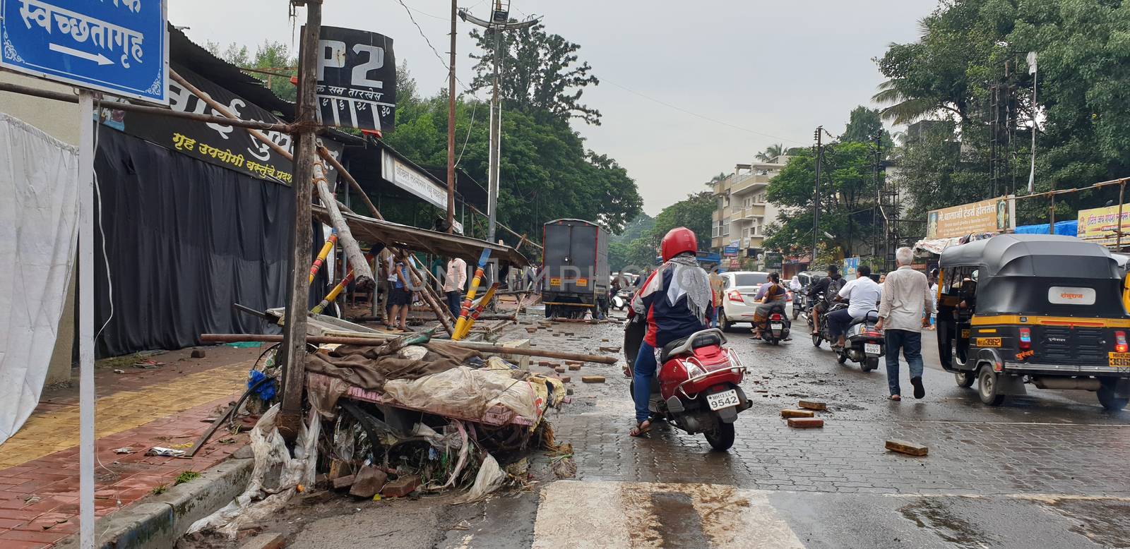 Pune, India - September 26, 2019: Sidewalks and road side cards destroyed in India due to floods during monsoons.