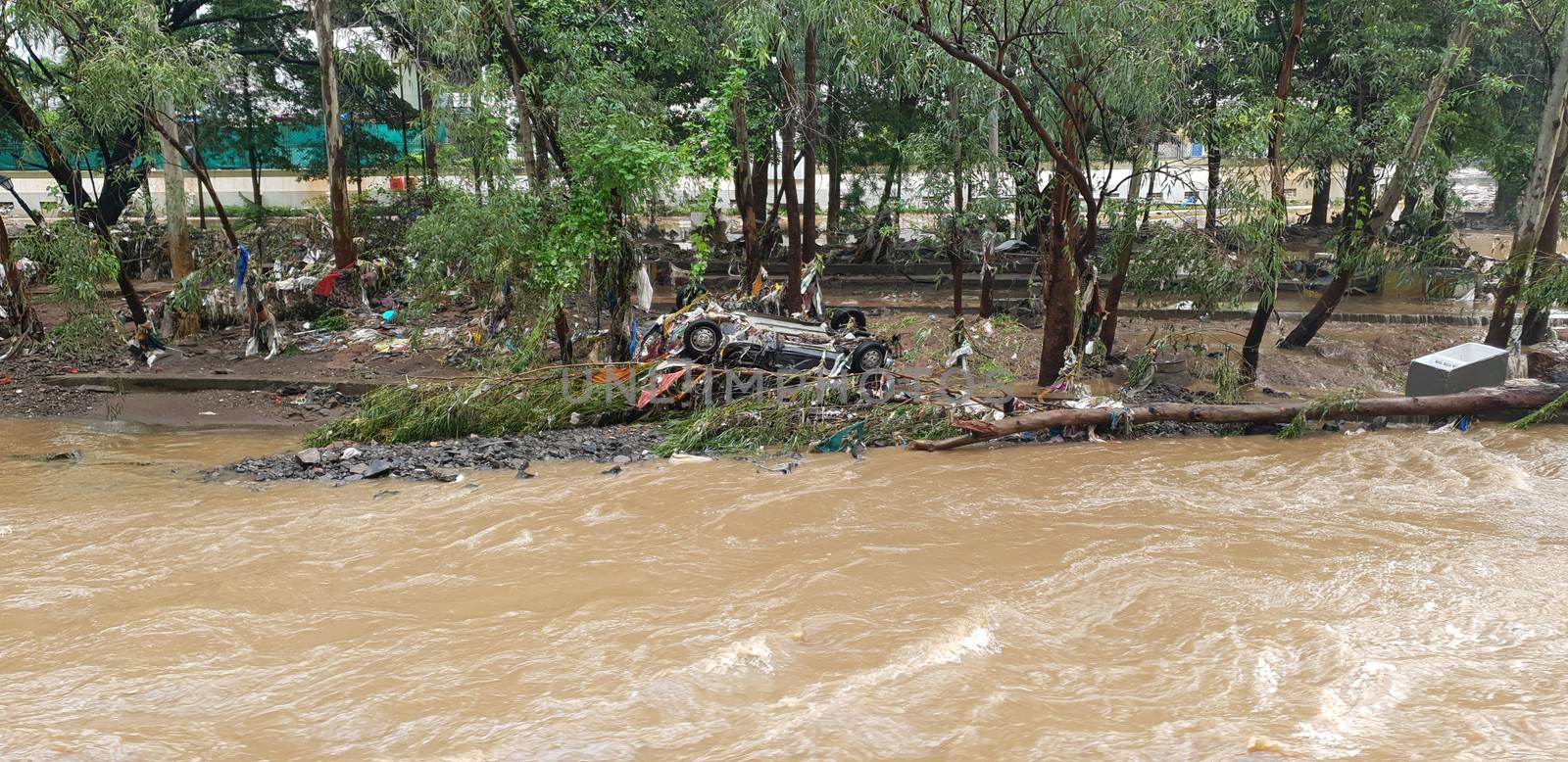 A car turned upside down after being washed away by flood waters in India during the monsoons.