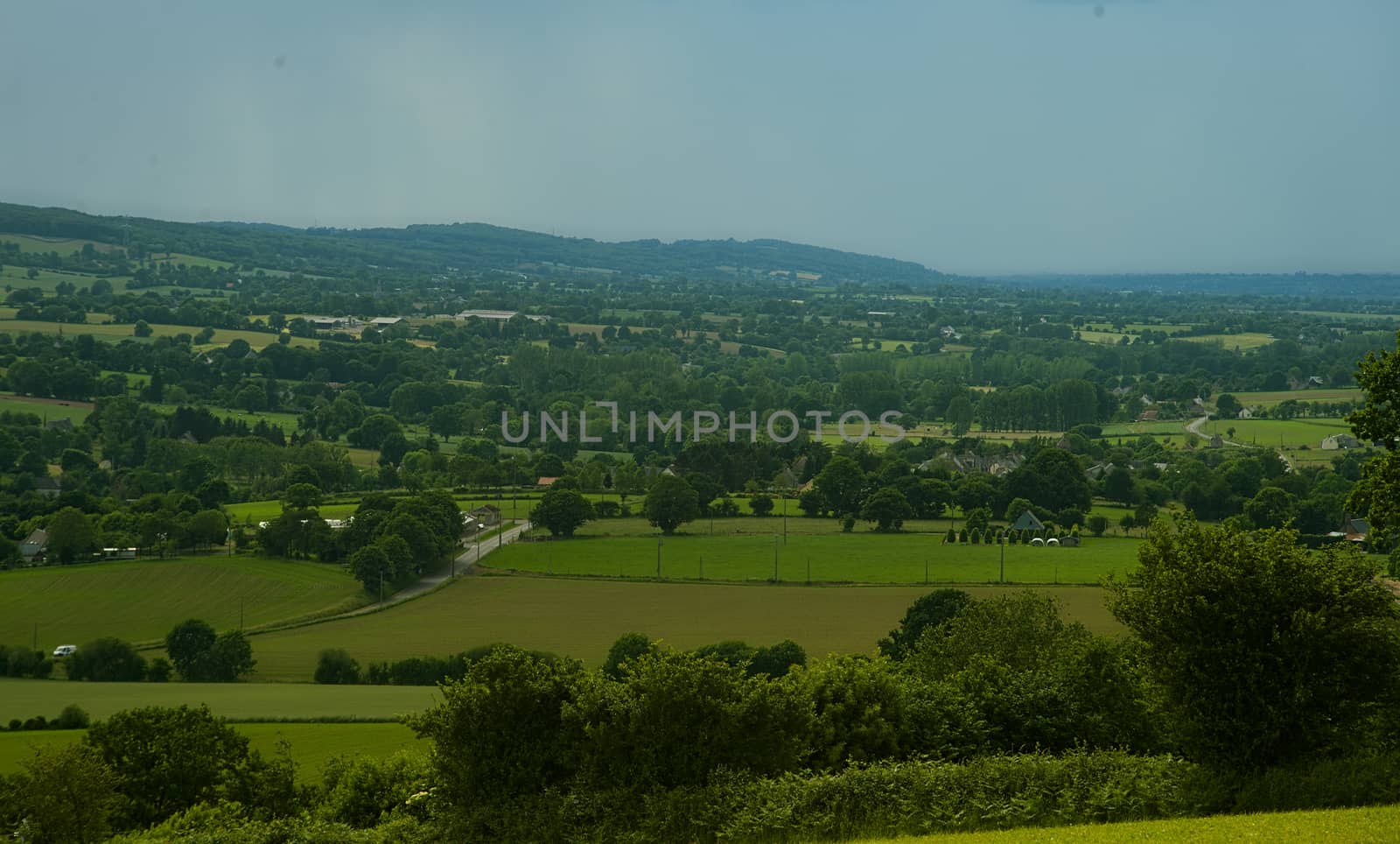 View from the hill on landscape in rural Normandy and storm forming in the distance by sheriffkule