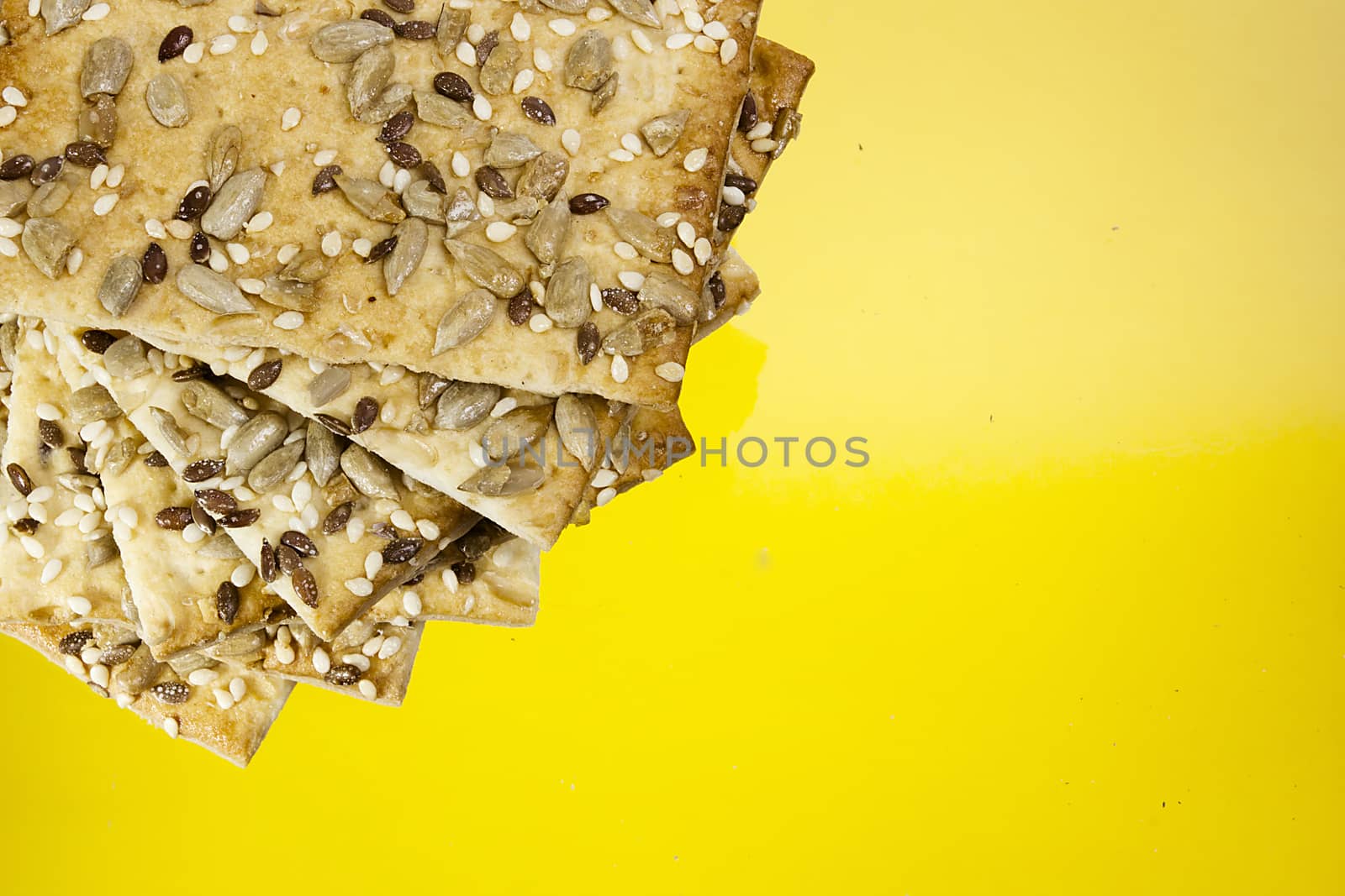 Salted crispy crackers with sesame and sunflower seeds