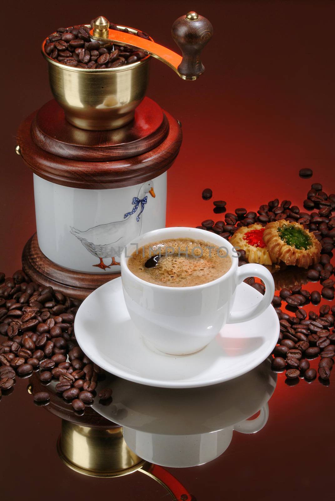 Cup of coffee, mill and cakes on a glass background
