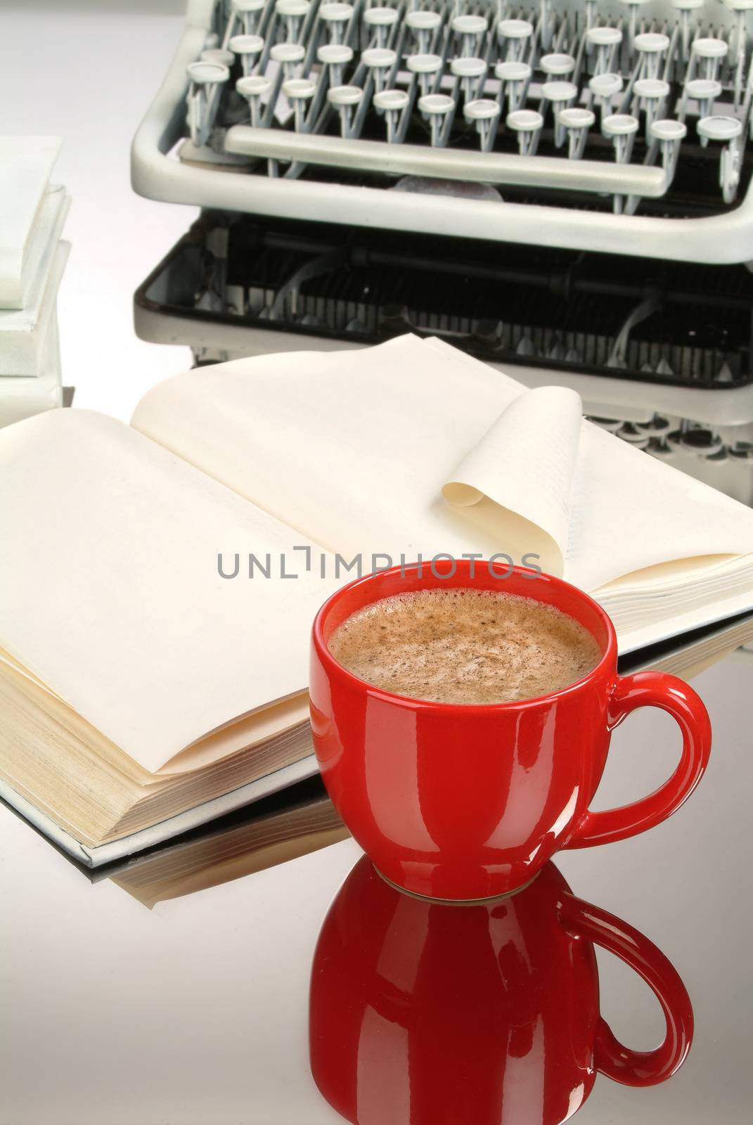 Cup of coffee, books and typewriter on a glass background