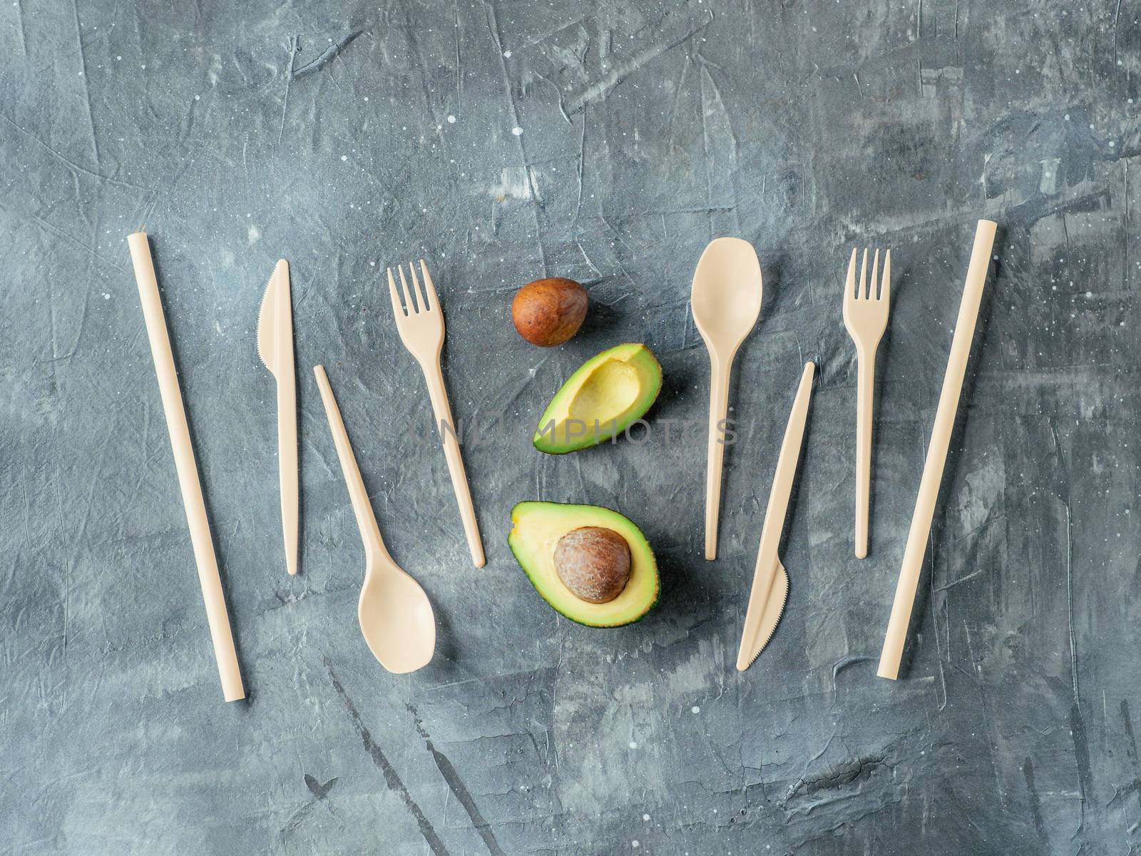 Avocado Seeds Biodegradable Single-Use Cutlery. Bioplastic - Great alternative to plastic disposable cutlery. Top view, flat lay. Gray background