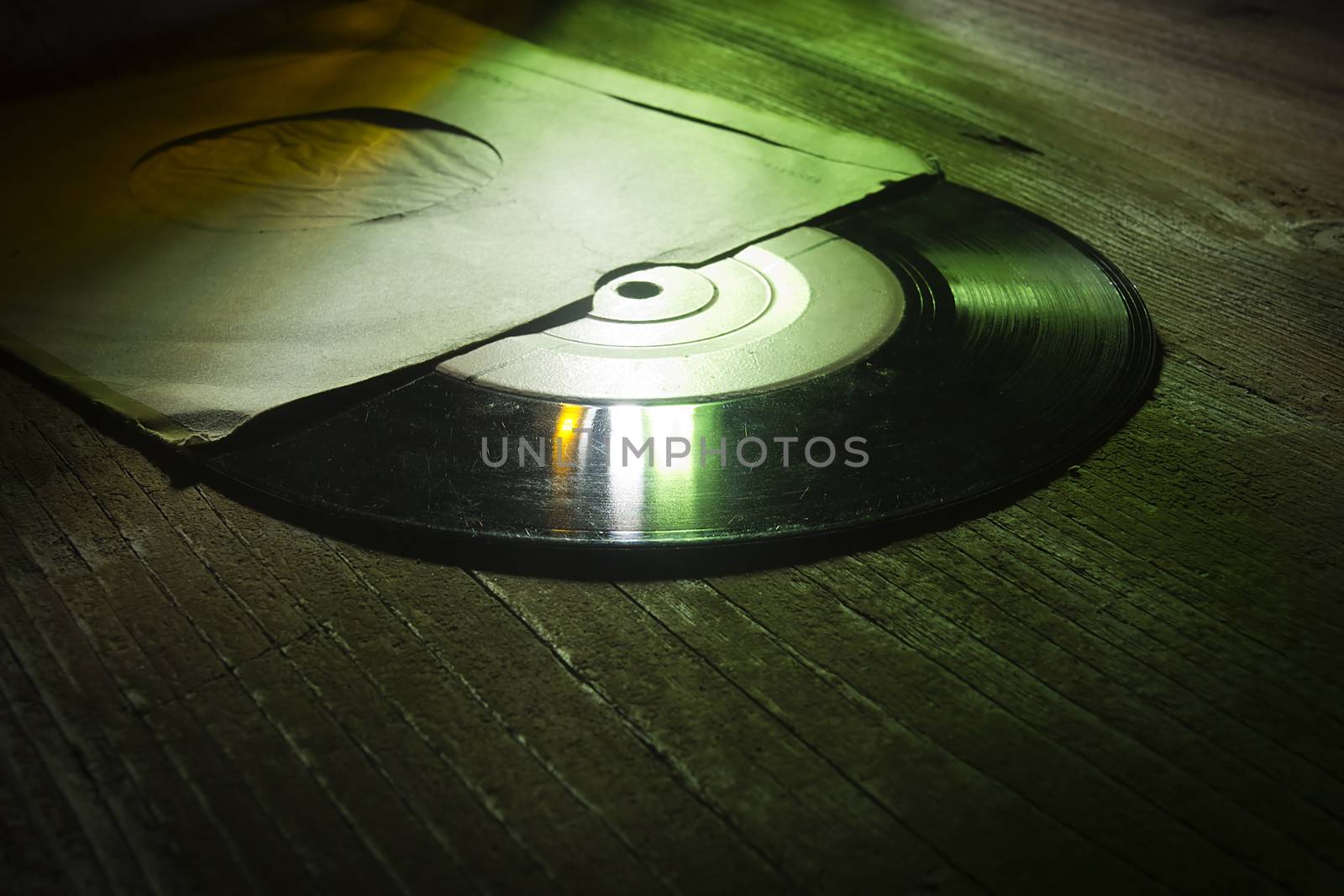 Vinyl record in an envelope on a wooden table