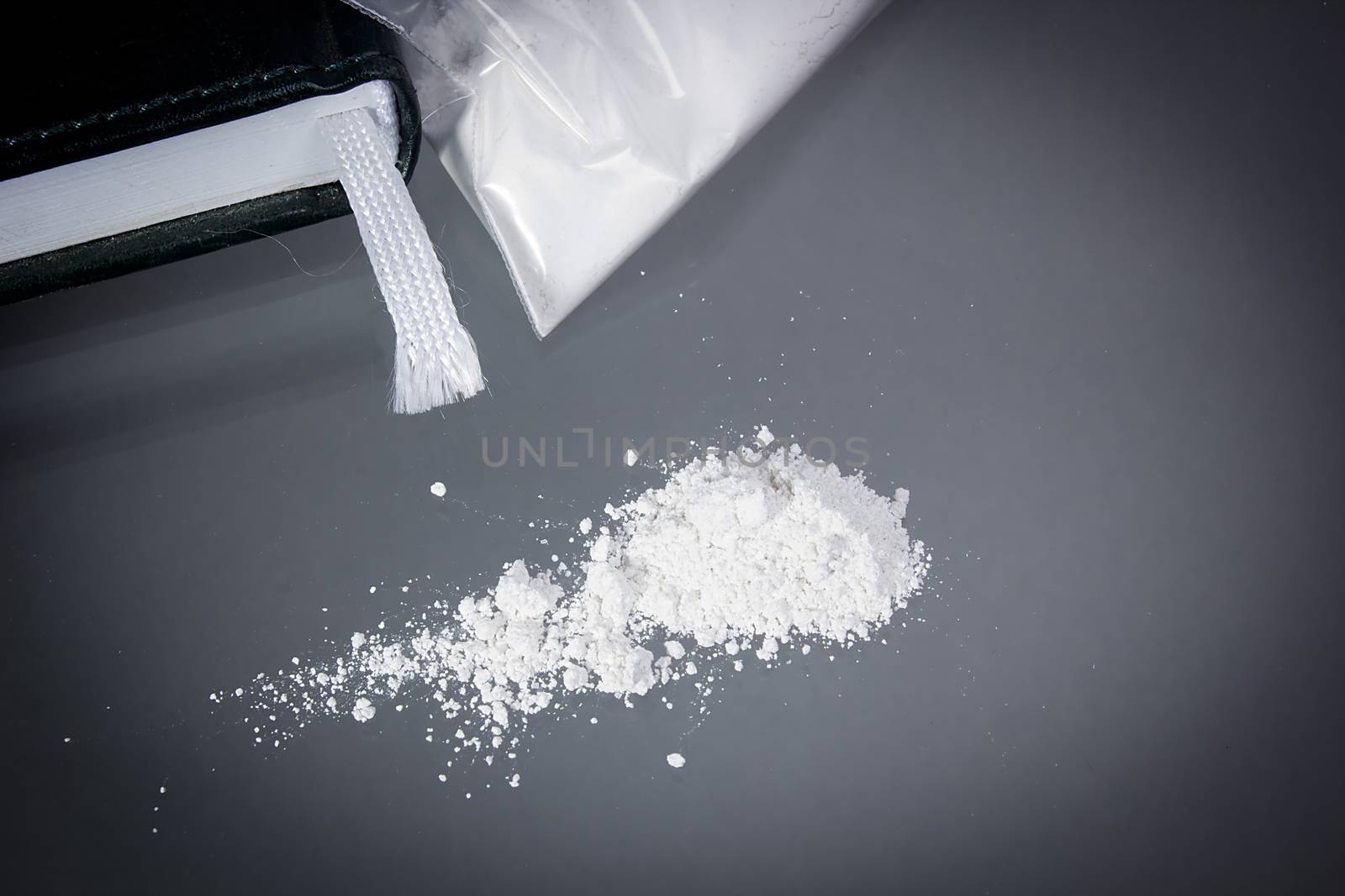 Drug cocaine in a bag and poured on a table