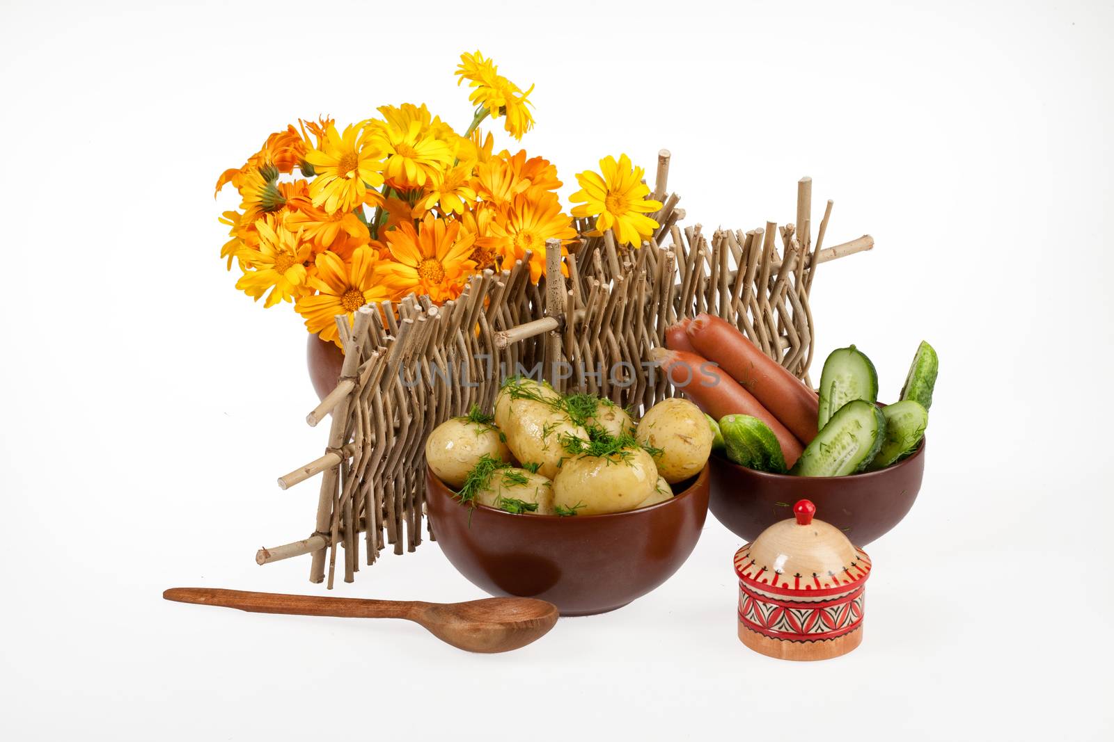 Potatoes, greenery and tableware on isolated satudio background