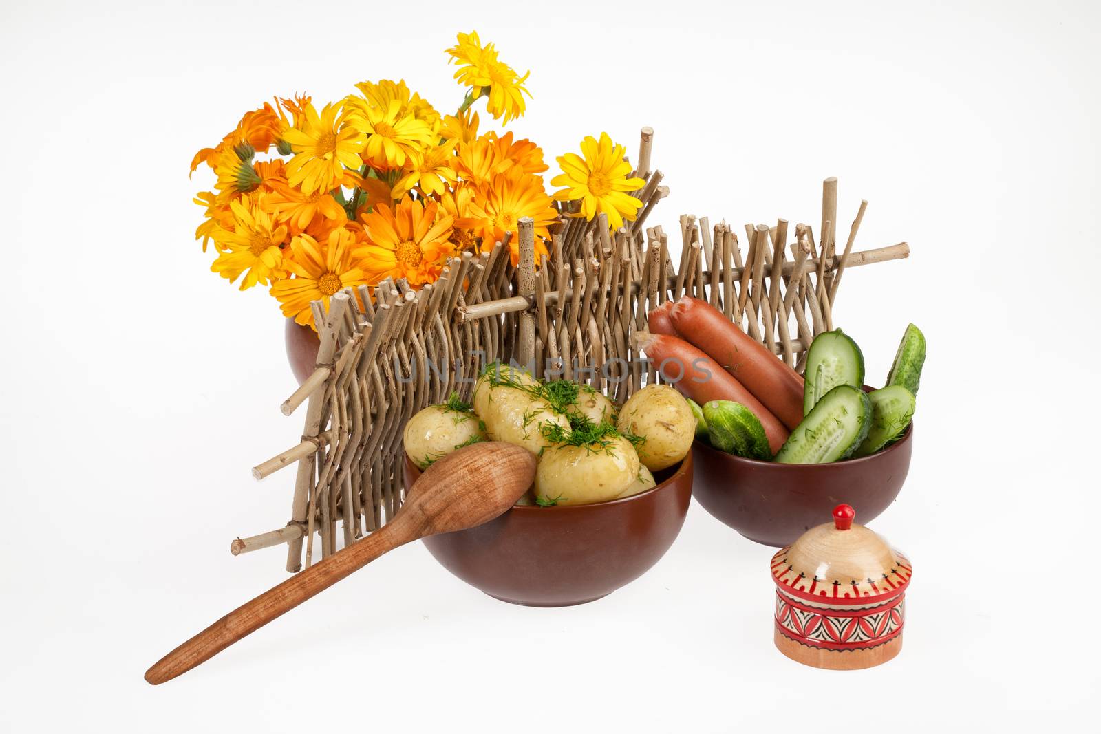 Potatoes, greenery and tableware on isolated satudio background