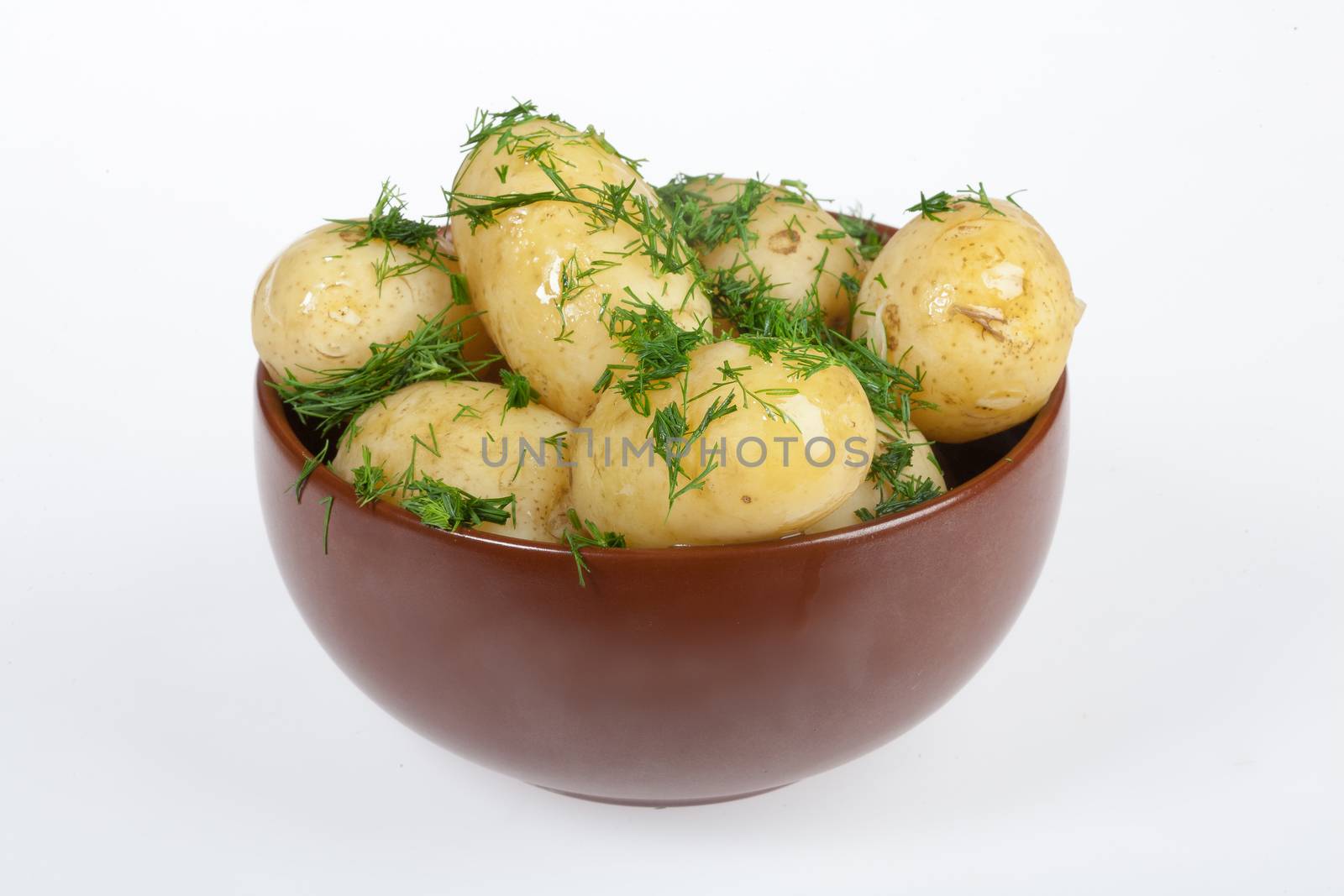 Potatoes, greenery and tableware on isolated satudio background