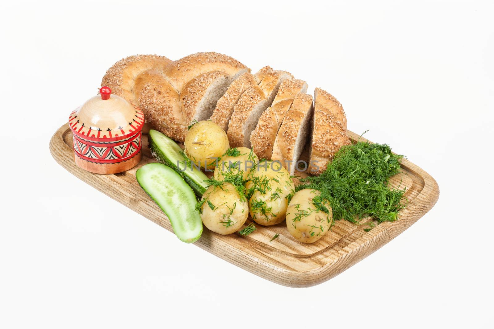 Potatoes, greenery and tableware on isolated satudio background