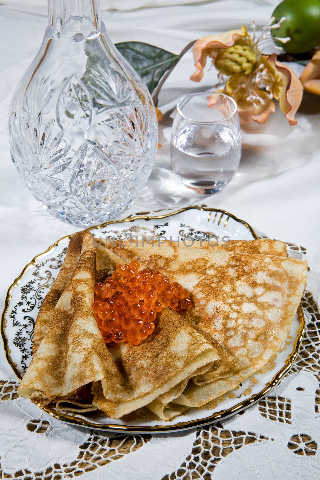 Pancakes with red caviar ona desk
