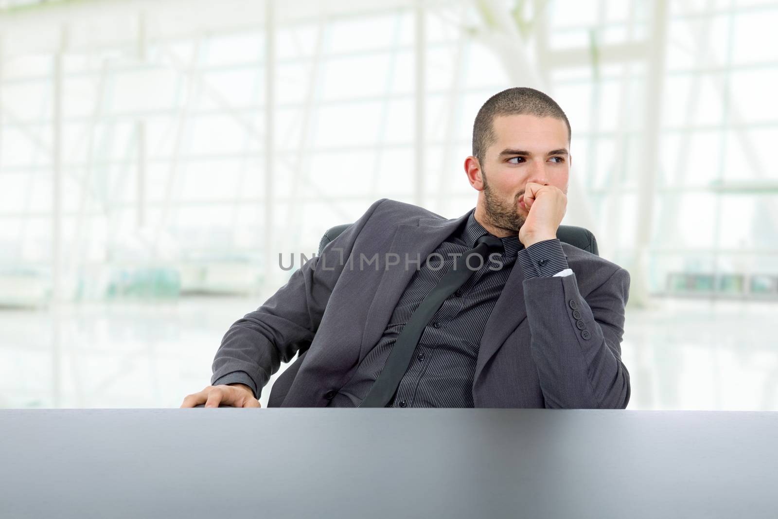 young business man thinking on a desk, at the office