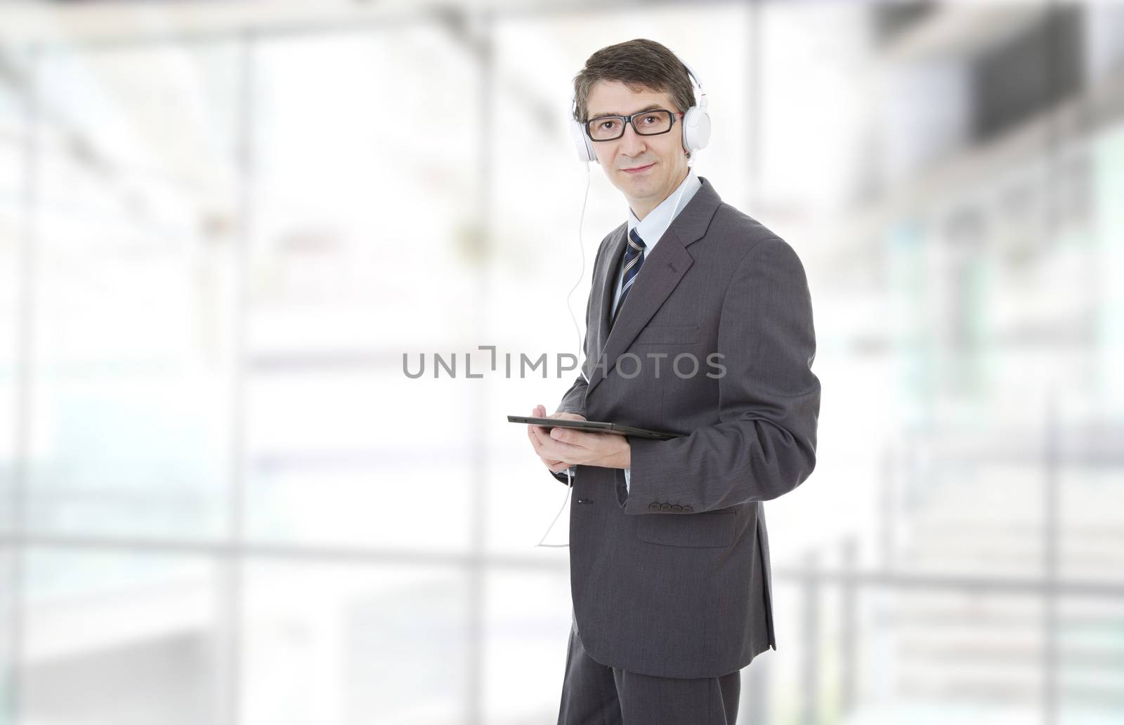 businessman working with tablet pc and headphones, at the office