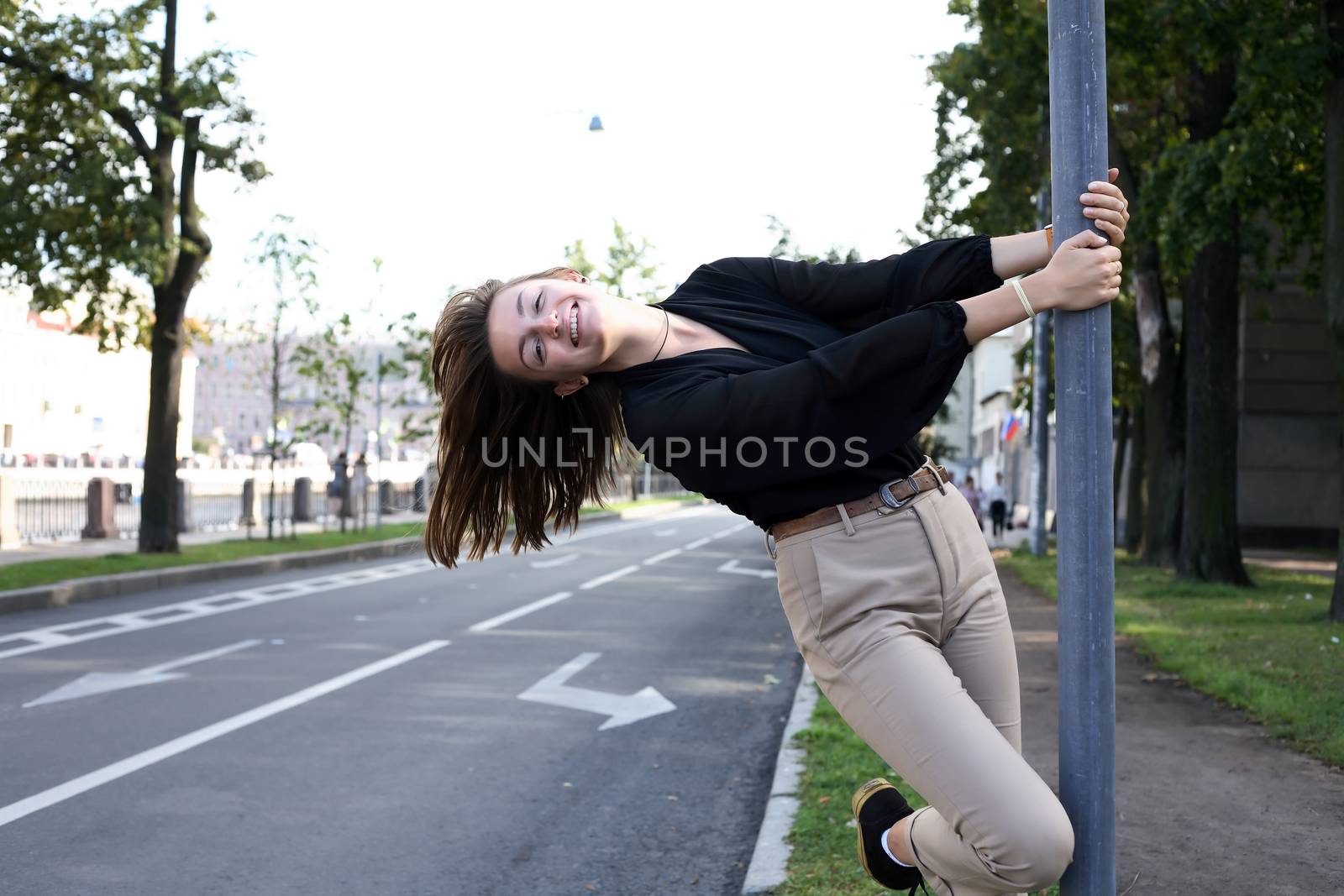 Beauty young woman near pillar against city view