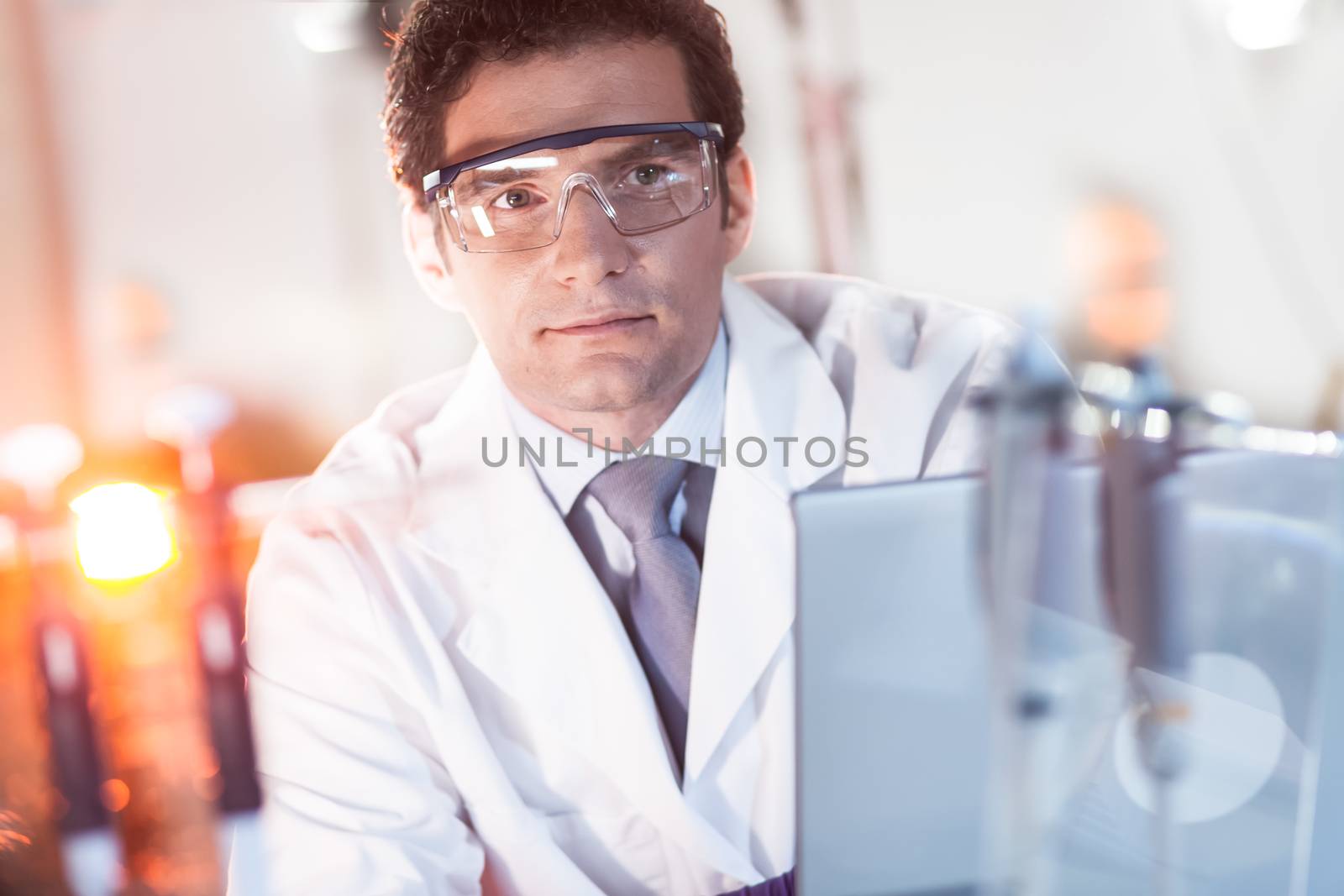 Portrait of a confident male engineer in his working environment. Science and technology concept.