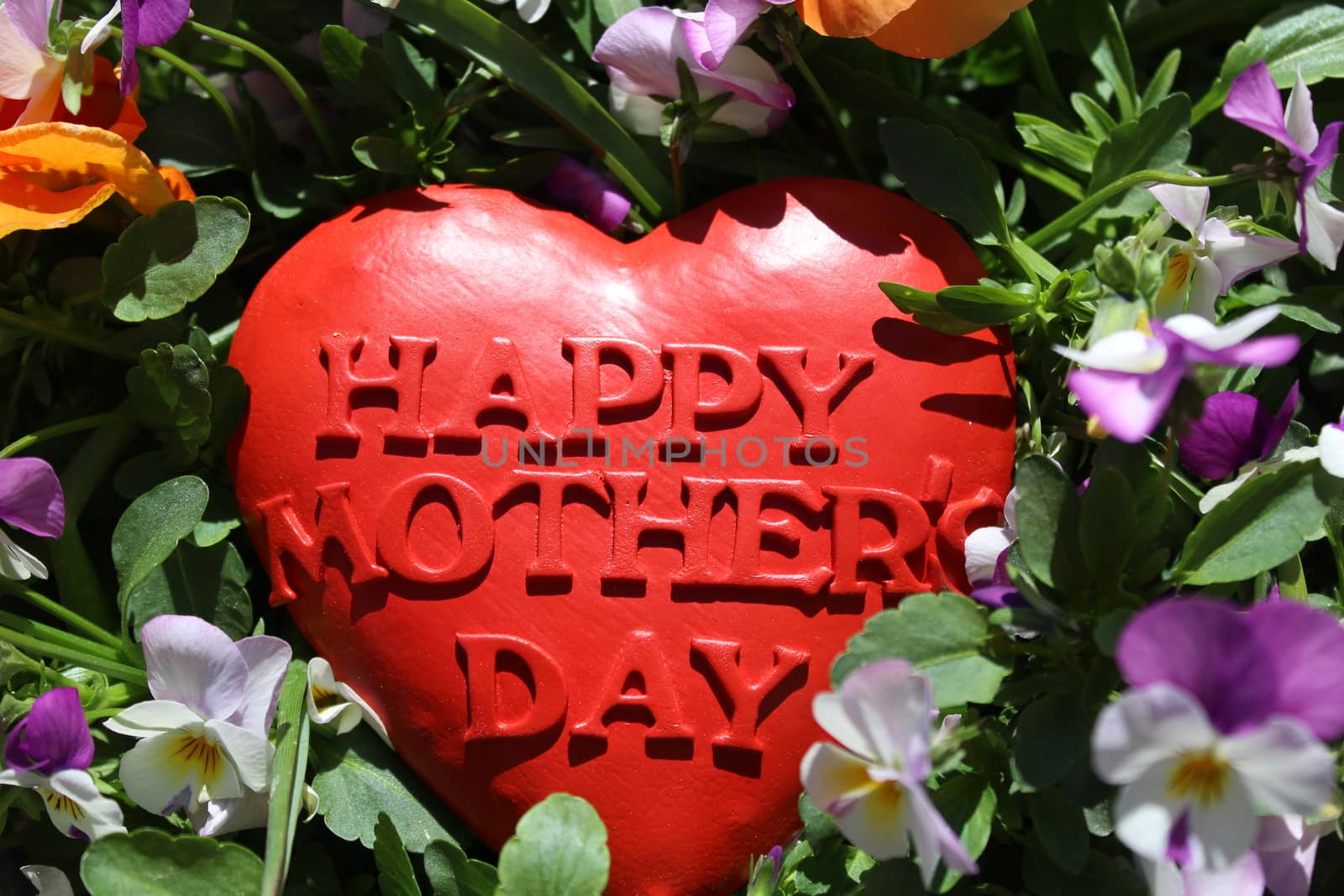 The picture shows a happy mother`s day decoration in flowers.
