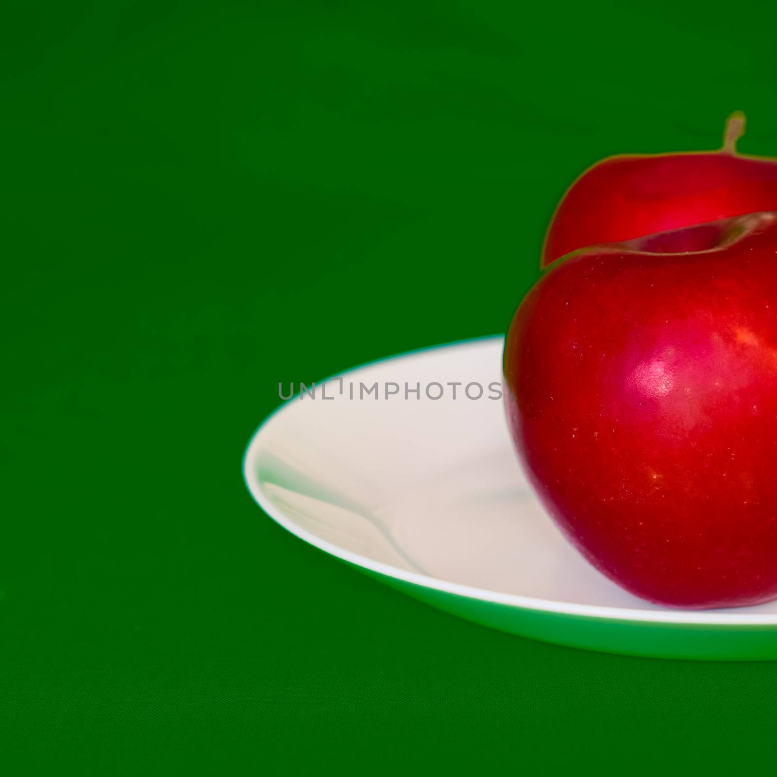 red apples on a white plate by alexandr_sorokin