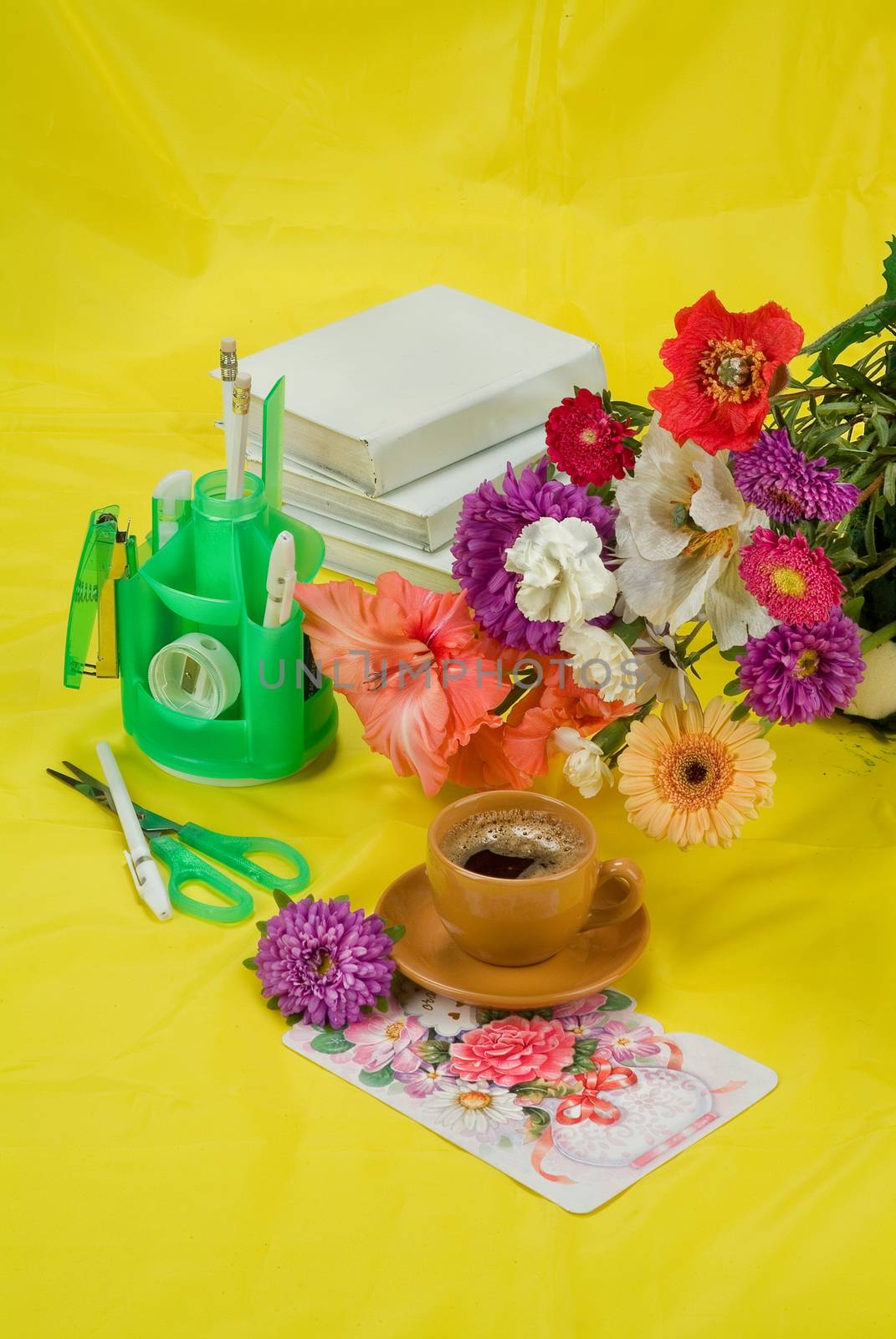 Still life with bouquet of flowers and accessories on a studio background