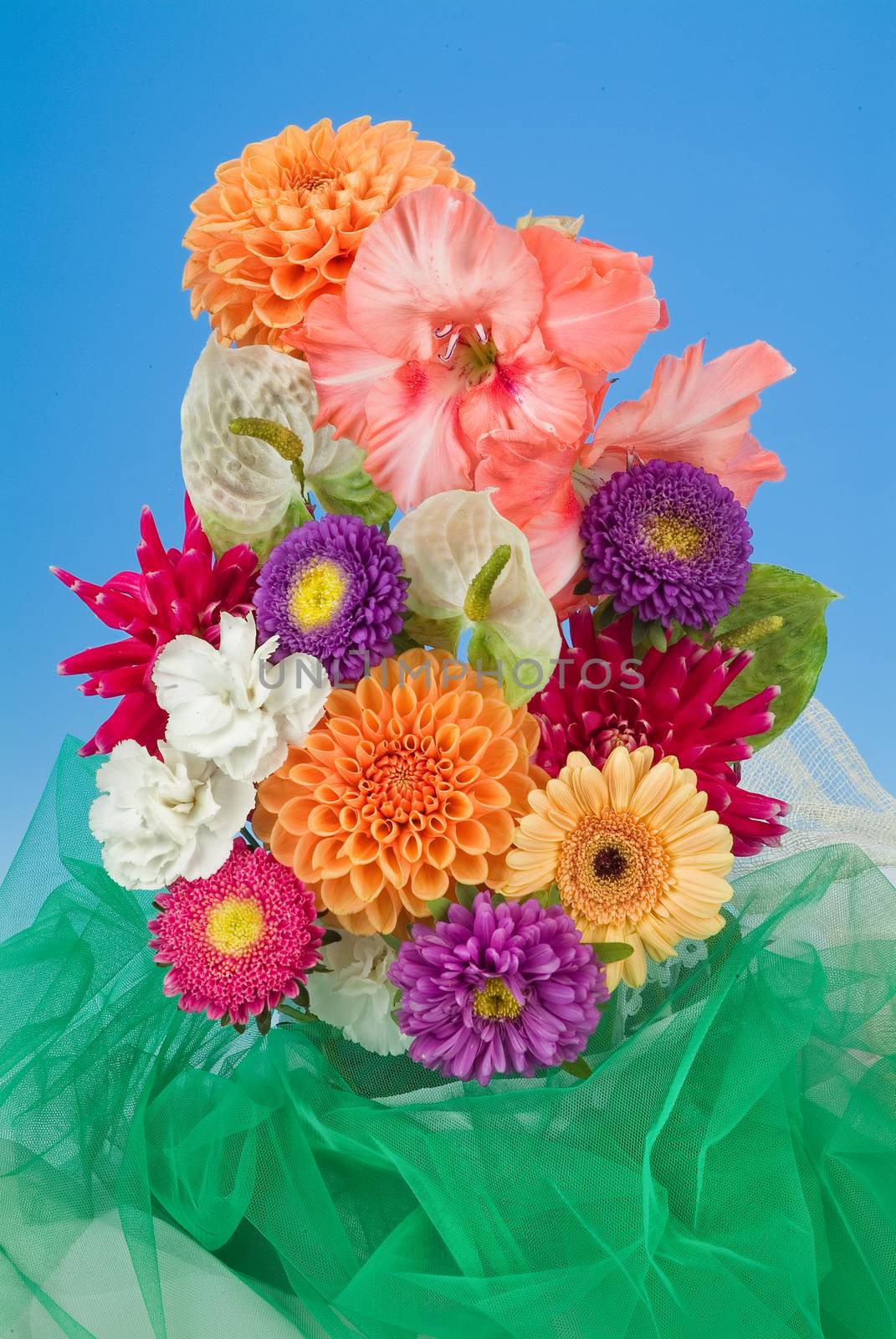 Still life with bouquet of flowers and accessories on a studio background