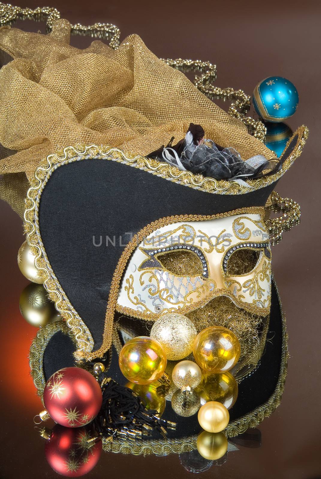 Mask and New Year balls on a glass studio background