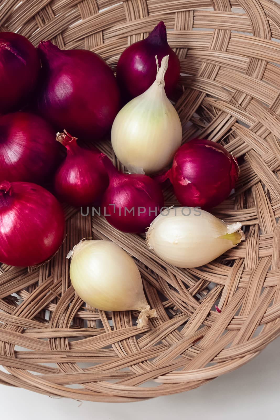 red onion and white onion wicker basket by alexandr_sorokin