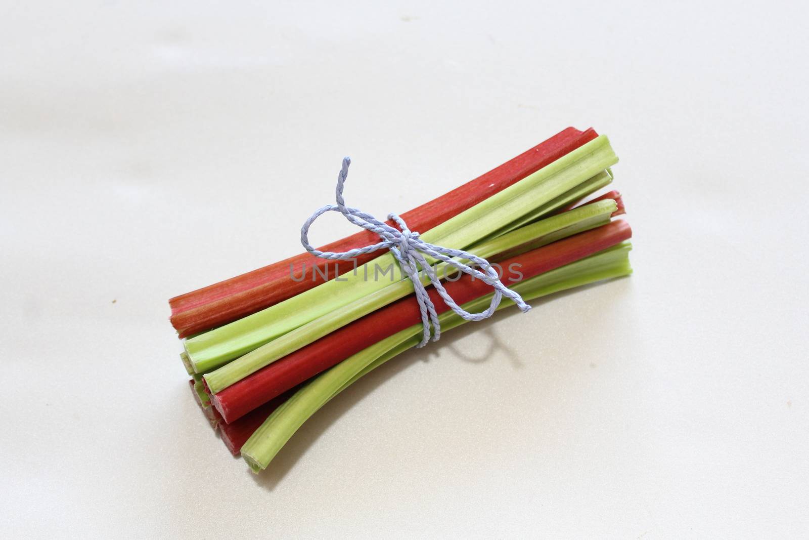 colorful delicious rhubarb on a white background by martina_unbehauen