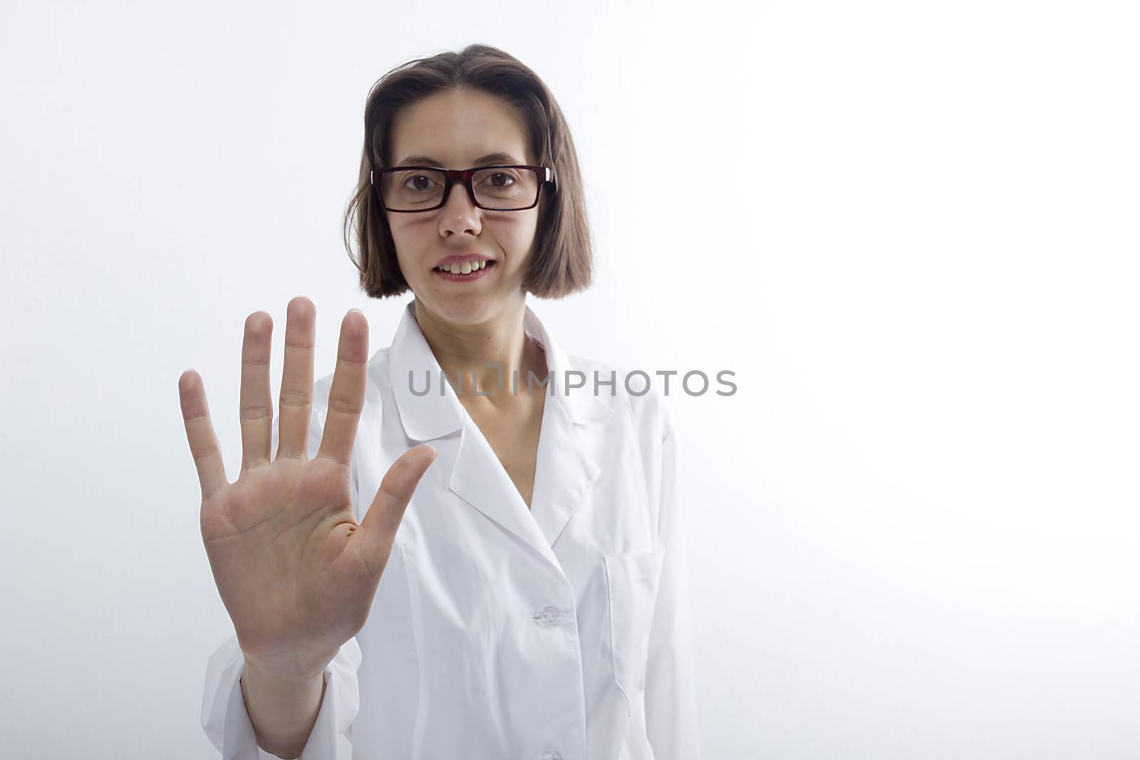 Female doctor raised her hand in greeting