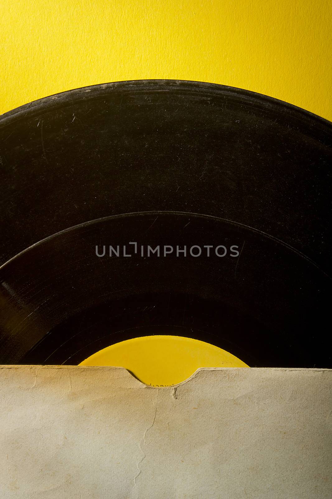 Vinyl record in an envelope on a yellow background