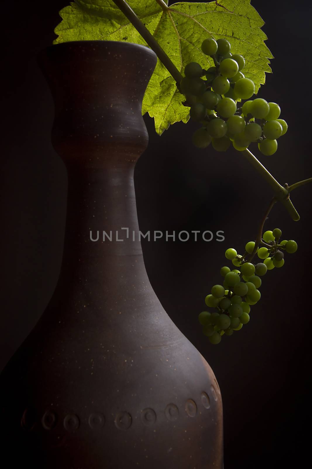 Clay bottle for wine on a black background