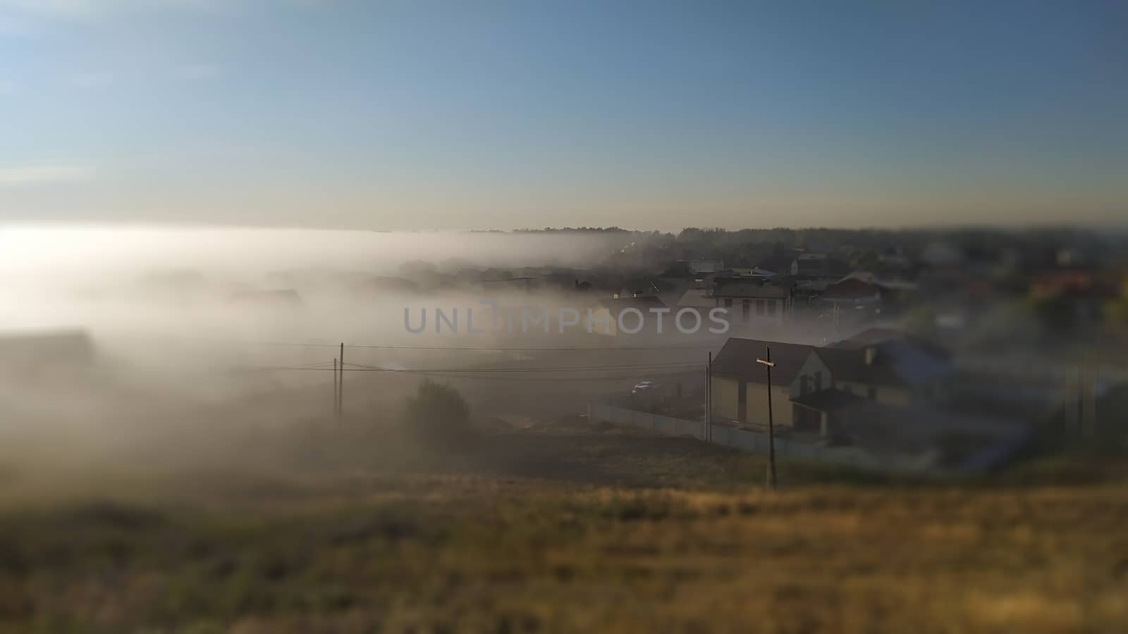Early Morning village in fog. Tilt shift effect by marynkin