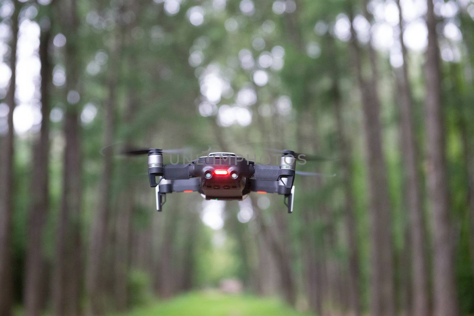 drone quad copter above the ground in a park by marynkin
