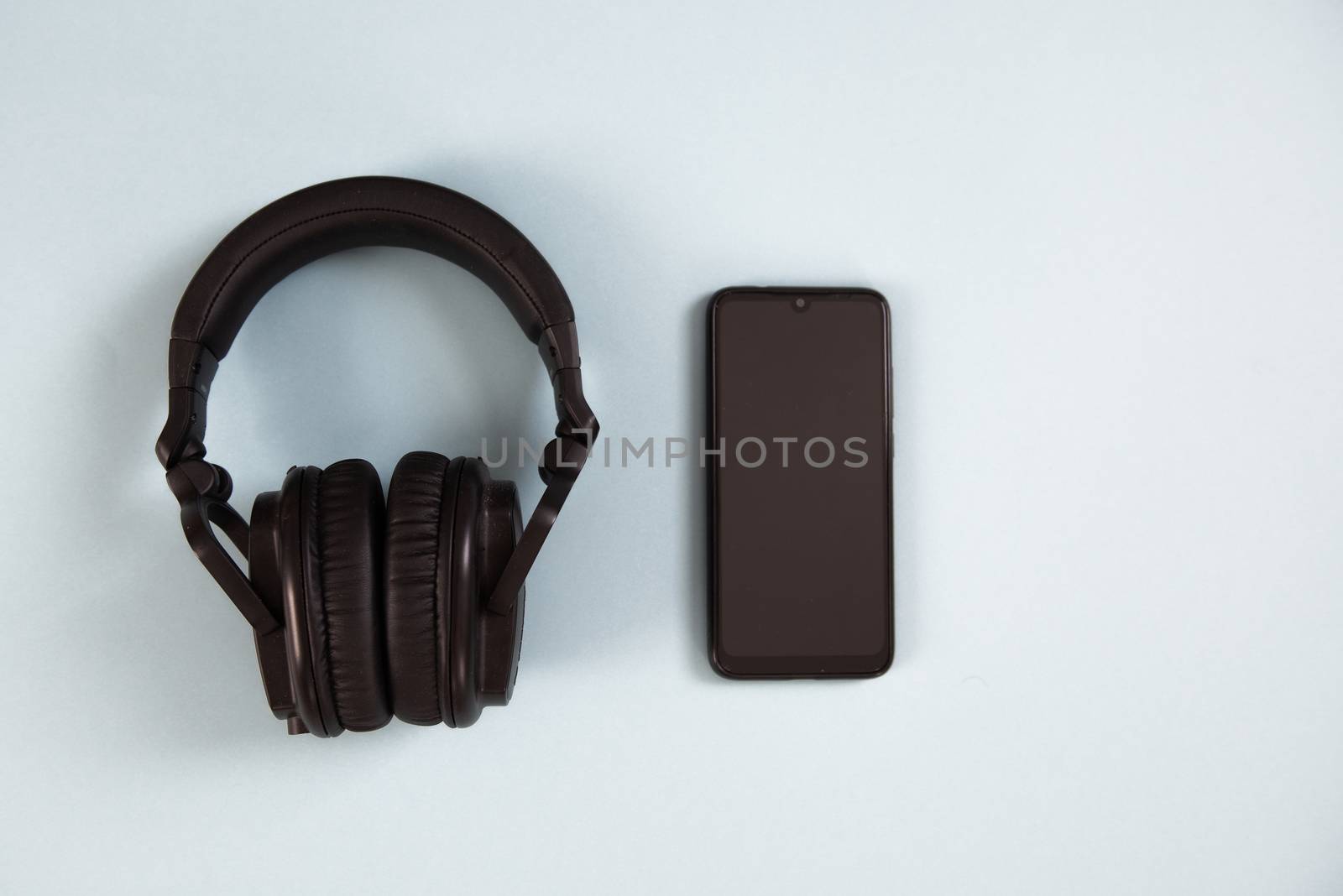 Wireless headphones with smartphone on white background by marynkin