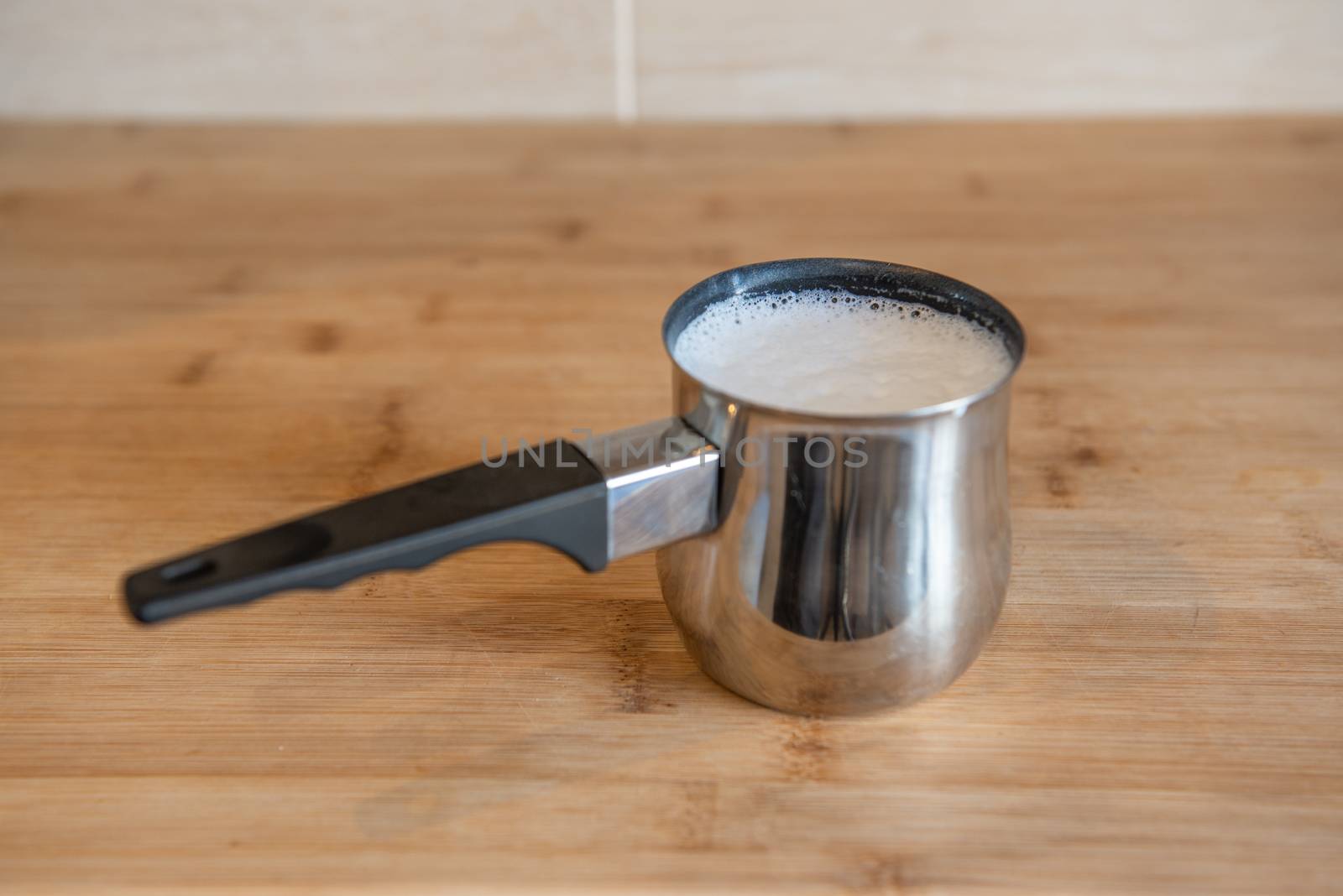 Stainless Steel Milk Pitcher with whipped milk by marynkin