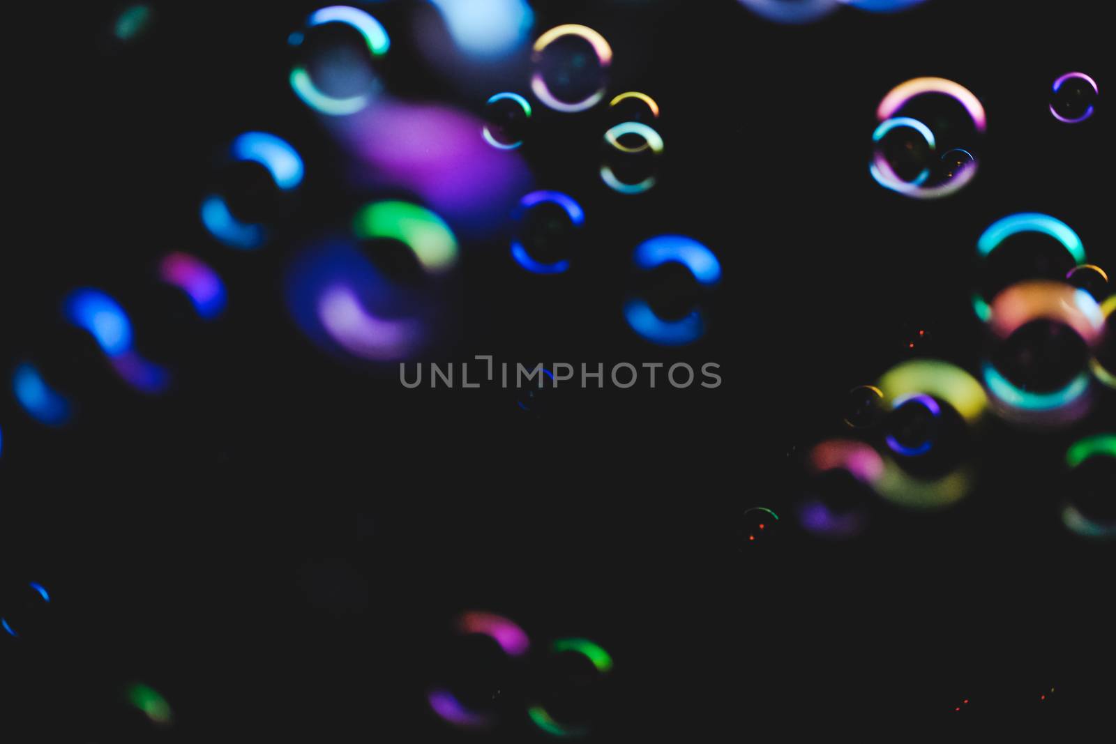 Colorful bubbles over dark background by mikelju
