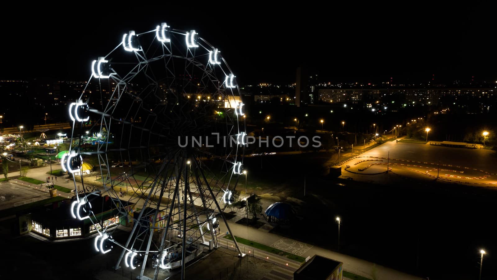 Ferris wheel in a night park. Entertainment in the park