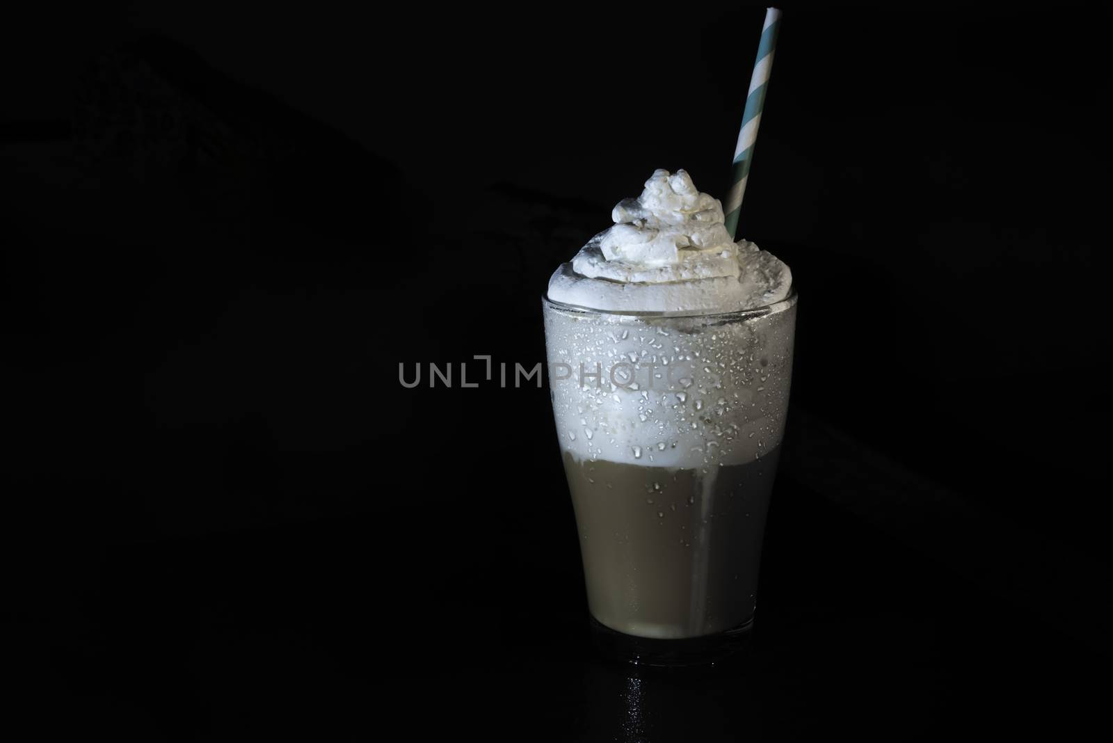 multilayer coffee or cappuccino in a glass cup with whipped cream by marynkin