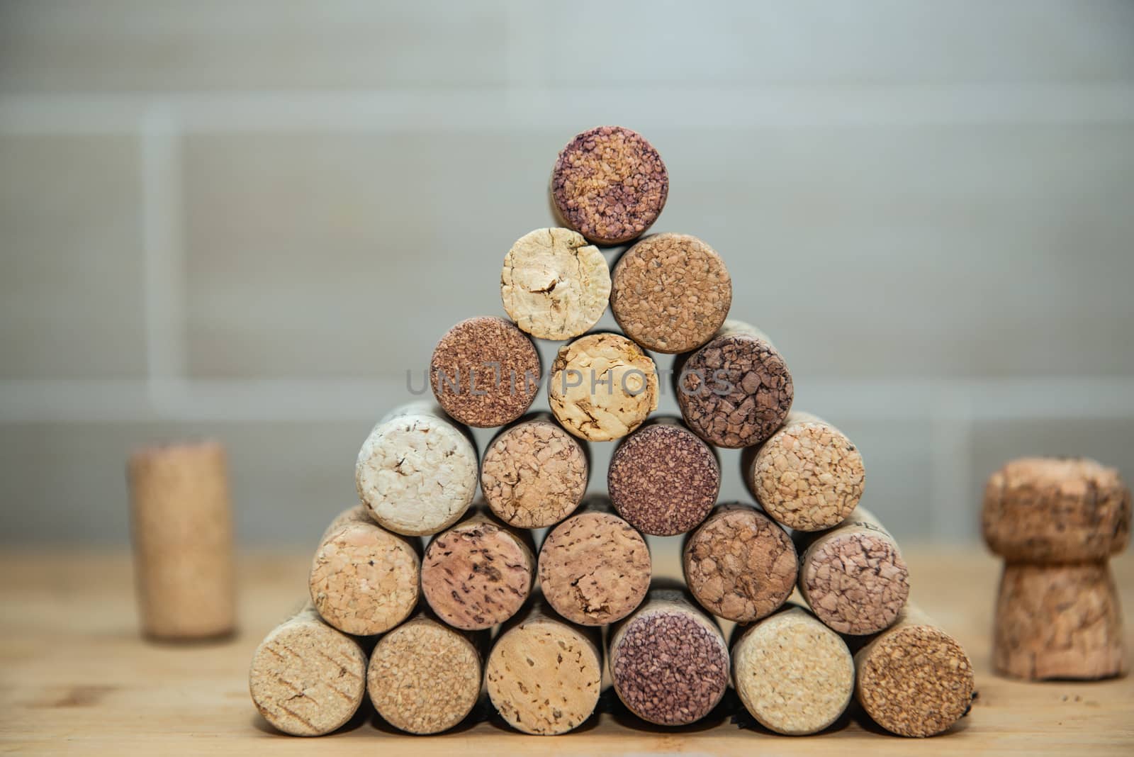 wine corks stacked on each other in a triangle by marynkin