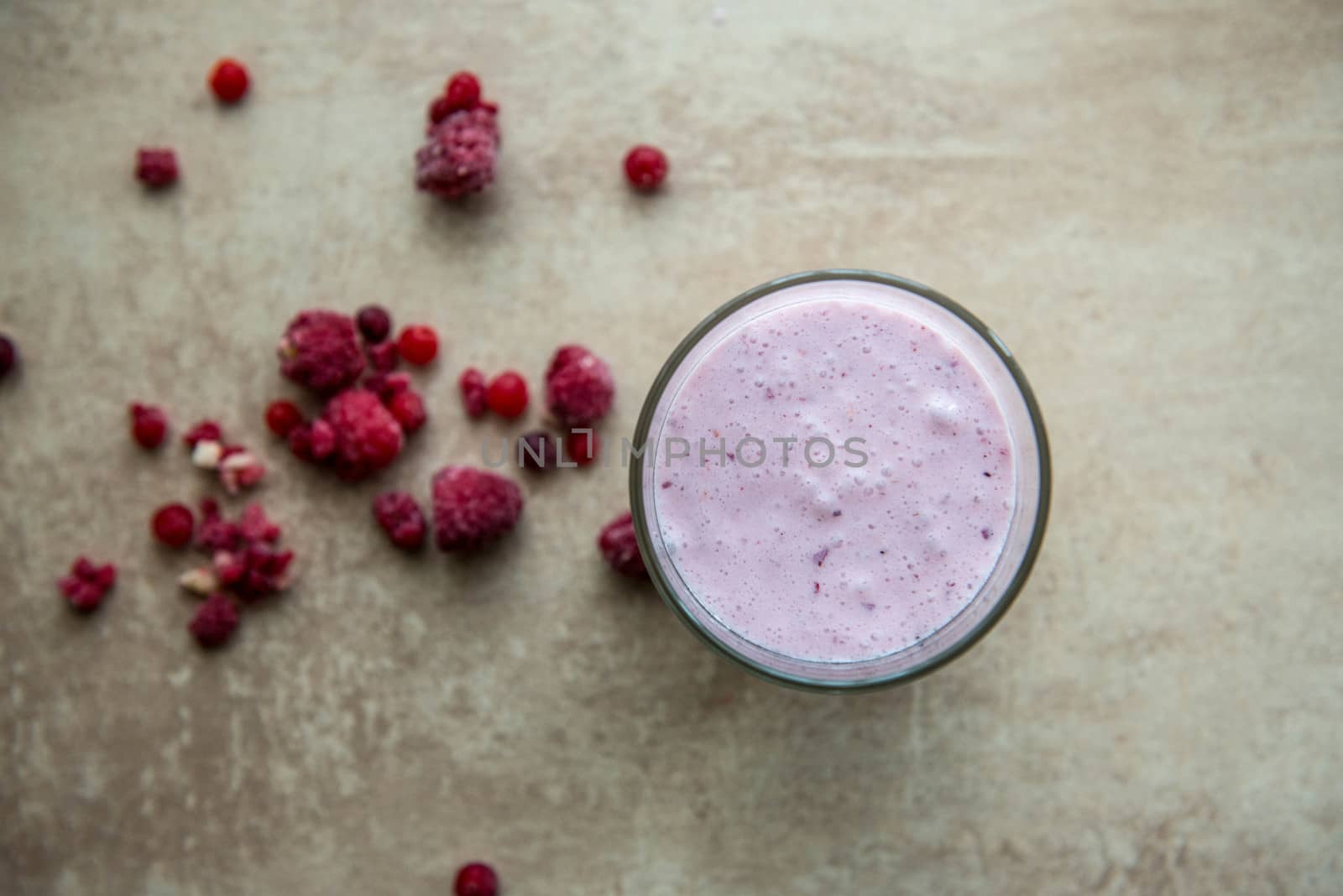 Creative layout made of raspberry, strawberry and coconut smoothie. Food concept. Smoothie on the grey background. by marynkin