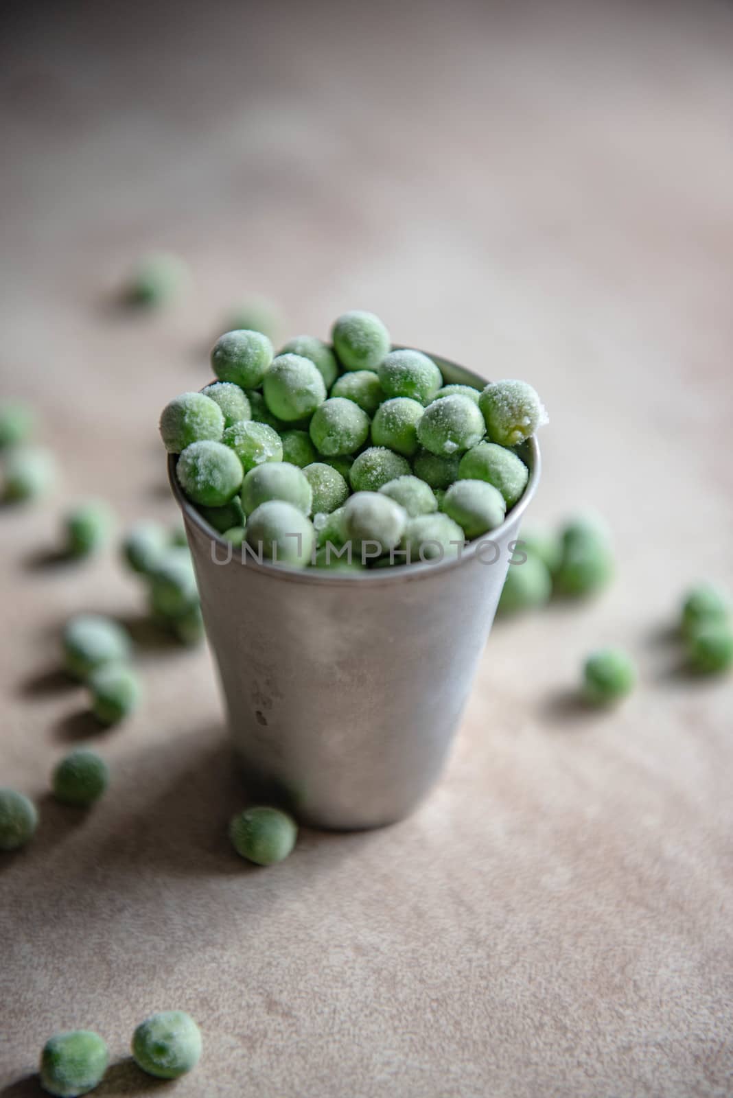 Small bucket with frozen peas.