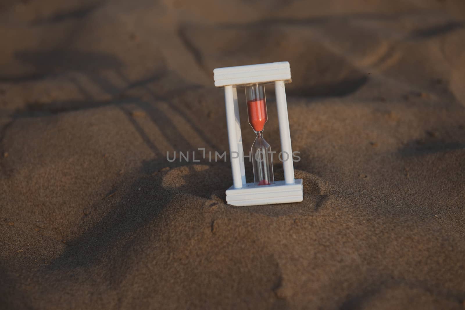 Hourglass on a sand dune beach by marynkin