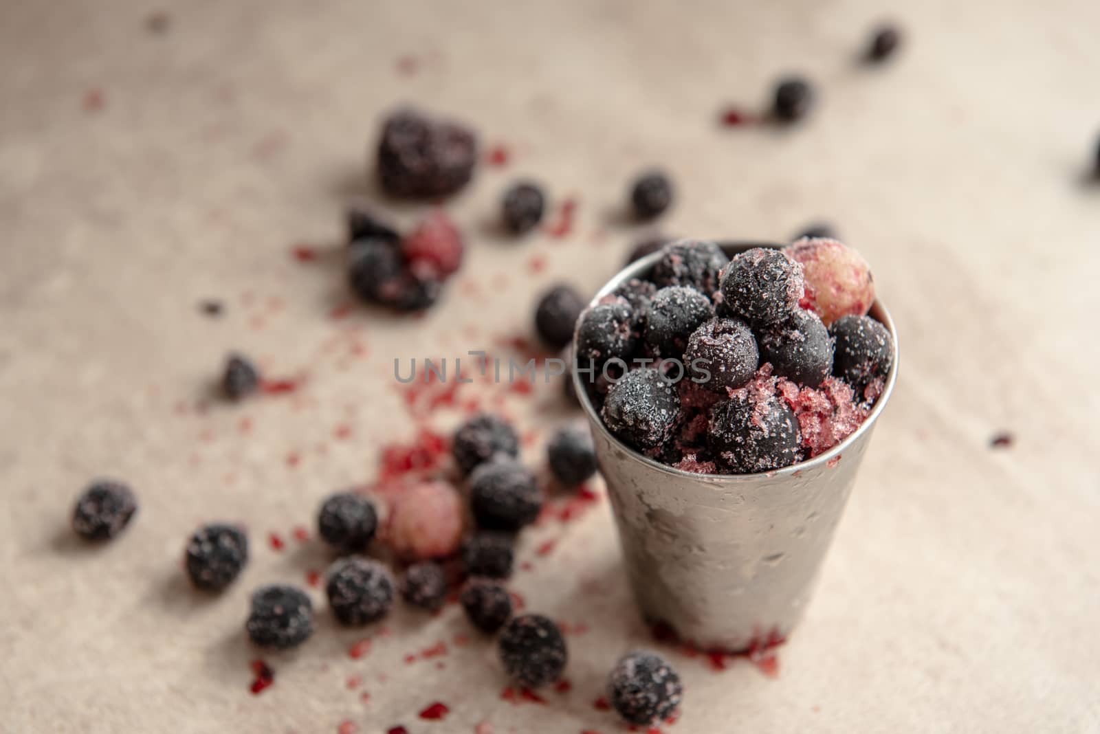 Small bucket with frozen young red berry by marynkin